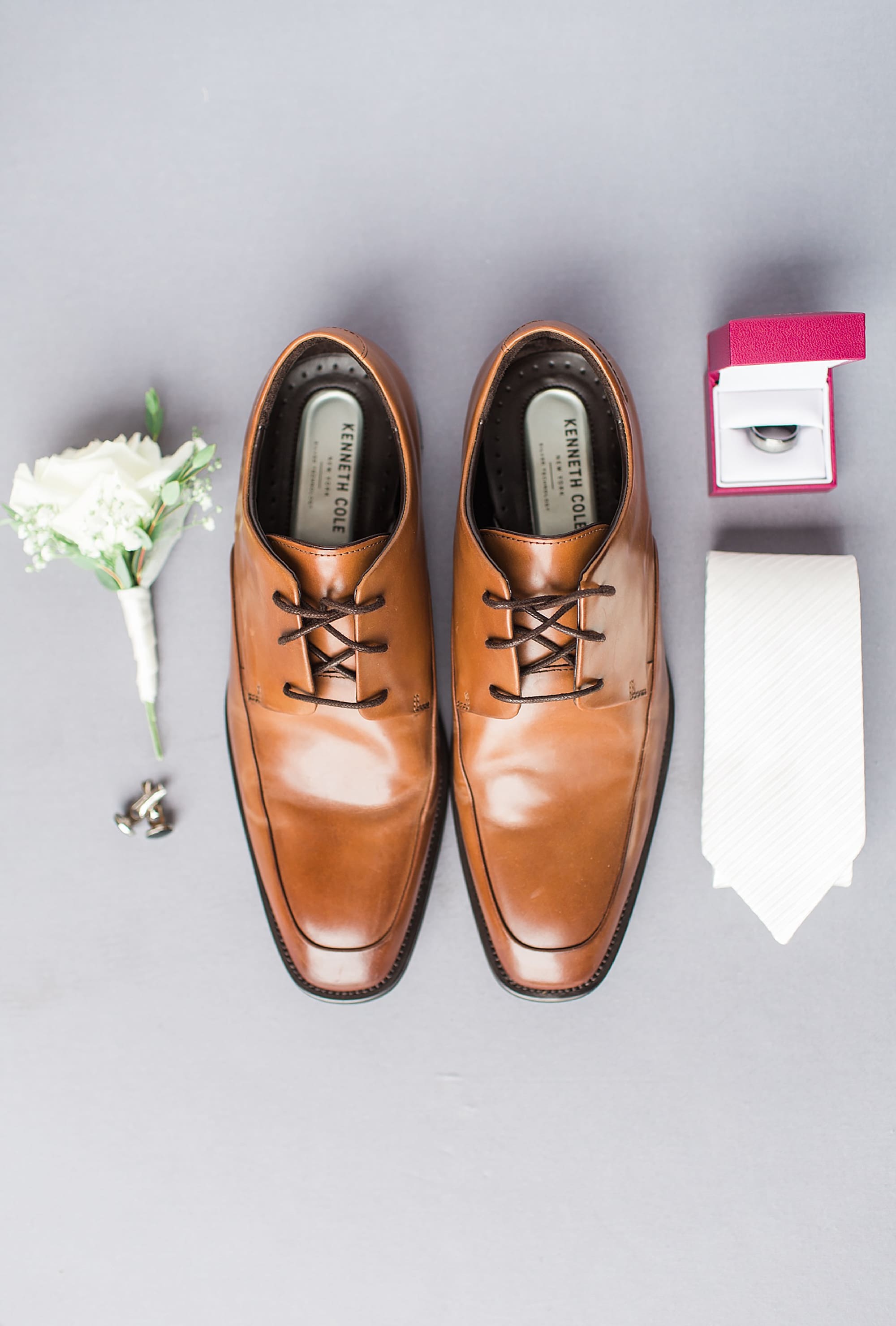 Arielle Peters Photography | Groom's shoes and tie on gray background on wedding day at Winona Heritage Room in Winona Lake, Indiana.