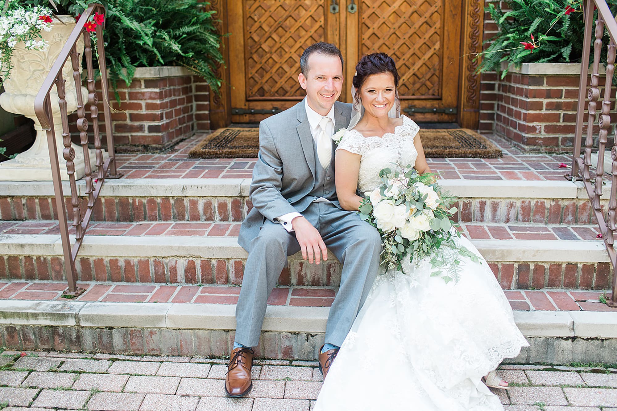 Arielle Peters Photography | Bride and groom sitting on brick steps on wedding day at Winona Heritage Room in Winona Lake, Indiana.