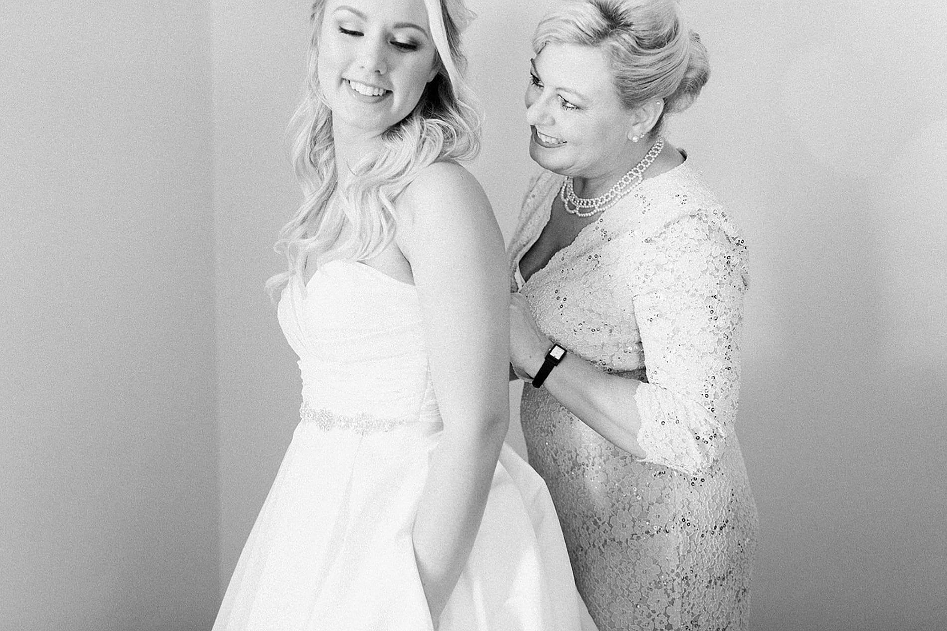 Arielle Peters Photography | Mother of bride helping bride get ready on wedding day at the Freemasons Hall in Fort Wayne, Indiana.