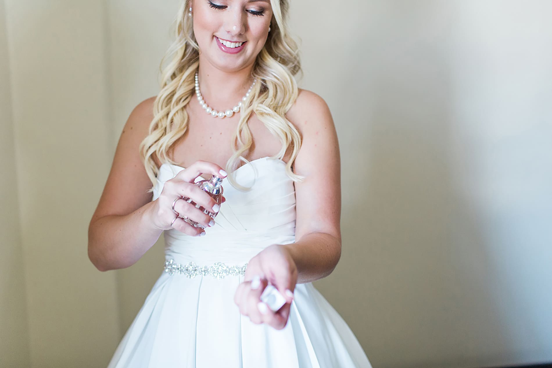 Arielle Peters Photography | Bride putting perfume on wedding day at the Freemasons Hall in Fort Wayne, Indiana.