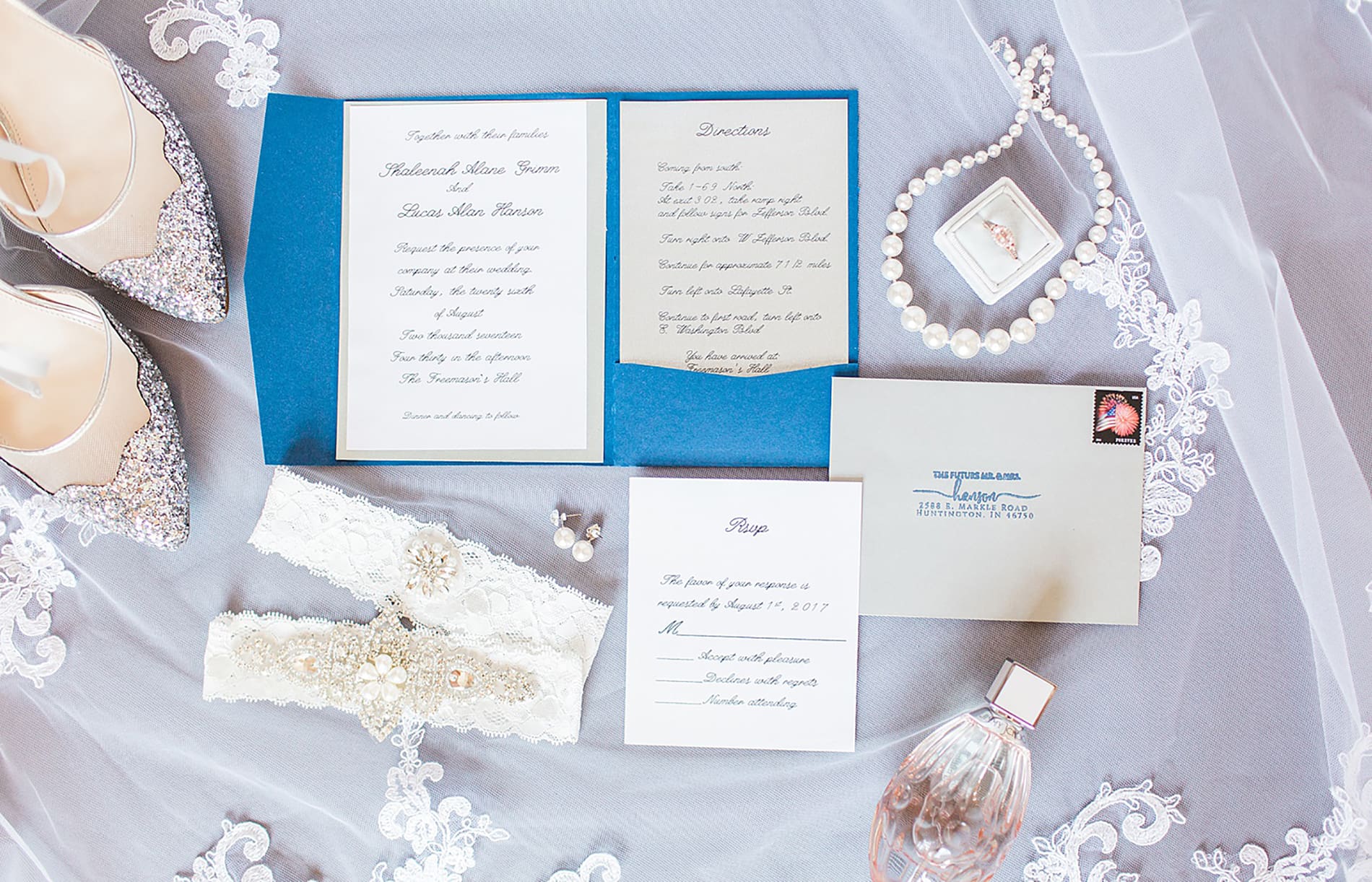 Arielle Peters Photography | Wedding invitation and jewelry on wedding day at the Freemasons Hall in Fort Wayne, Indiana.
