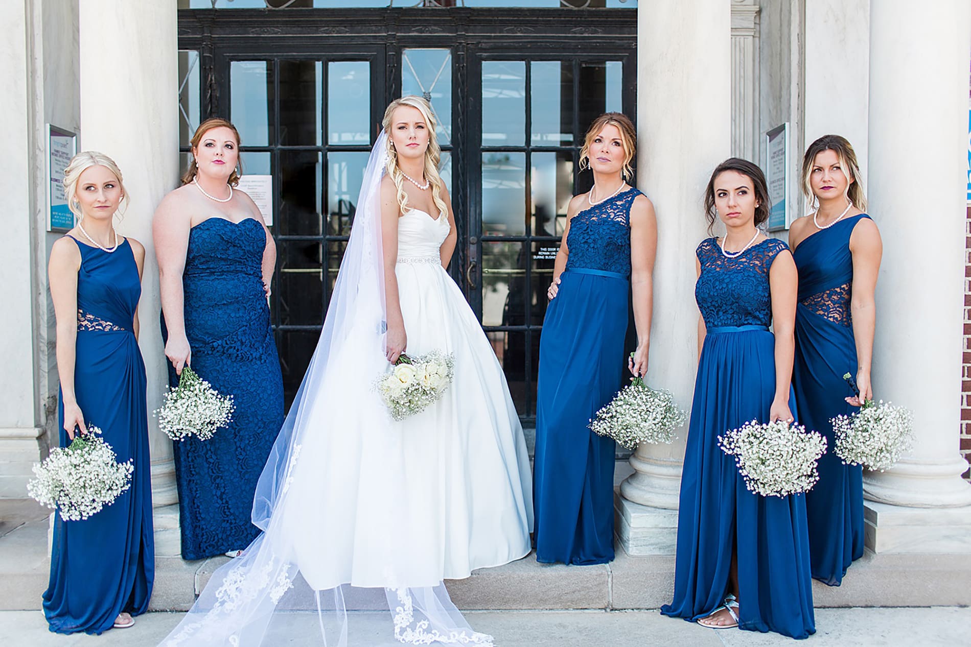 Arielle Peters Photography | Bride and bridesmaids next to columns on wedding day at the Freemasons Hall in Fort Wayne, Indiana.
