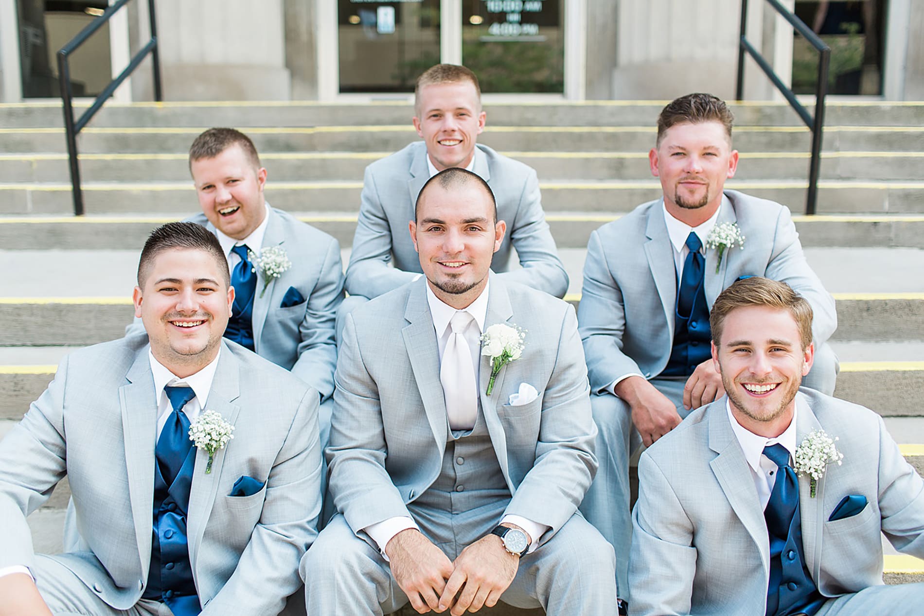 Arielle Peters Photography | Groom and groomsmen sitting on church steps on wedding day at the Freemasons Hall in Fort Wayne, Indiana.