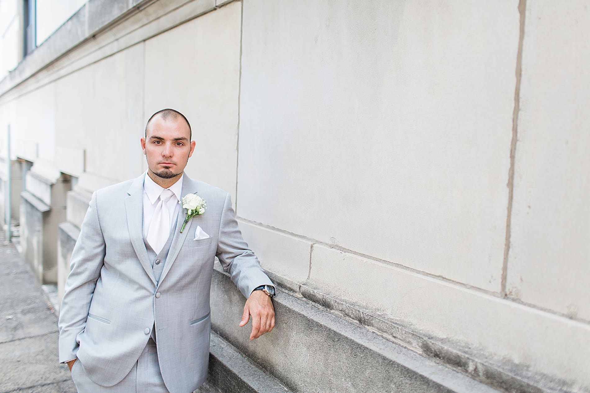 Arielle Peters Photography | Groom leaning against church on wedding day at the Freemasons Hall in Fort Wayne, Indiana.