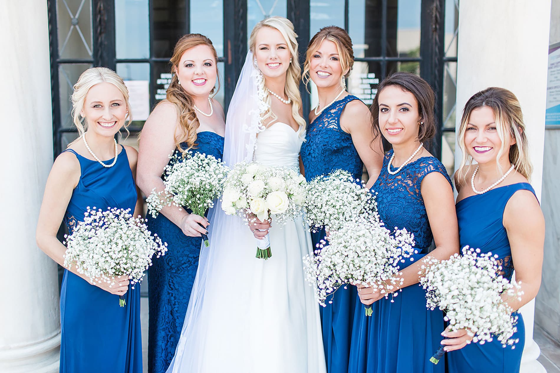 Arielle Peters Photography | Bride and bridesmaids next to columns on wedding day at the Freemasons Hall in Fort Wayne, Indiana.