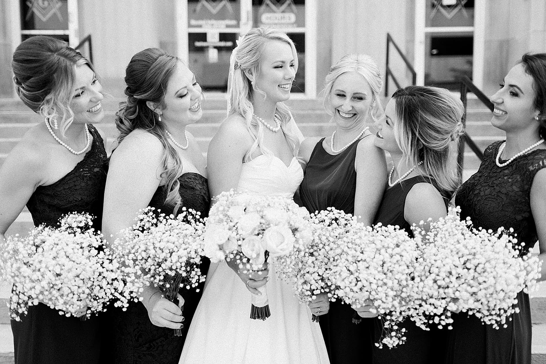 Arielle Peters Photography | Bride and bridesmaids next to church steps on wedding day at the Freemasons Hall in Fort Wayne, Indiana.