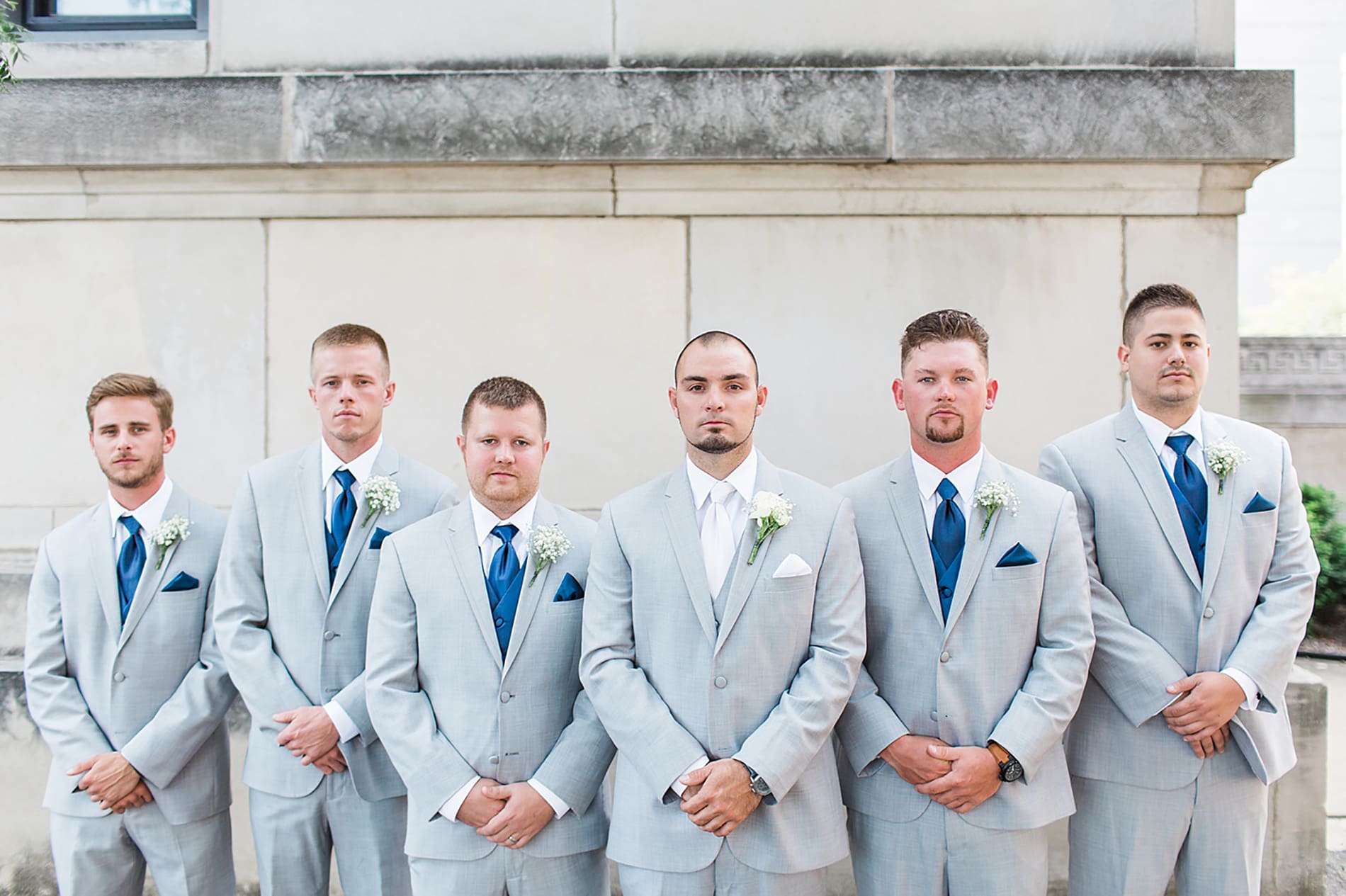 Arielle Peters Photography | Groom and groomsmen standing next to church on wedding day at the Freemasons Hall in Fort Wayne, Indiana.