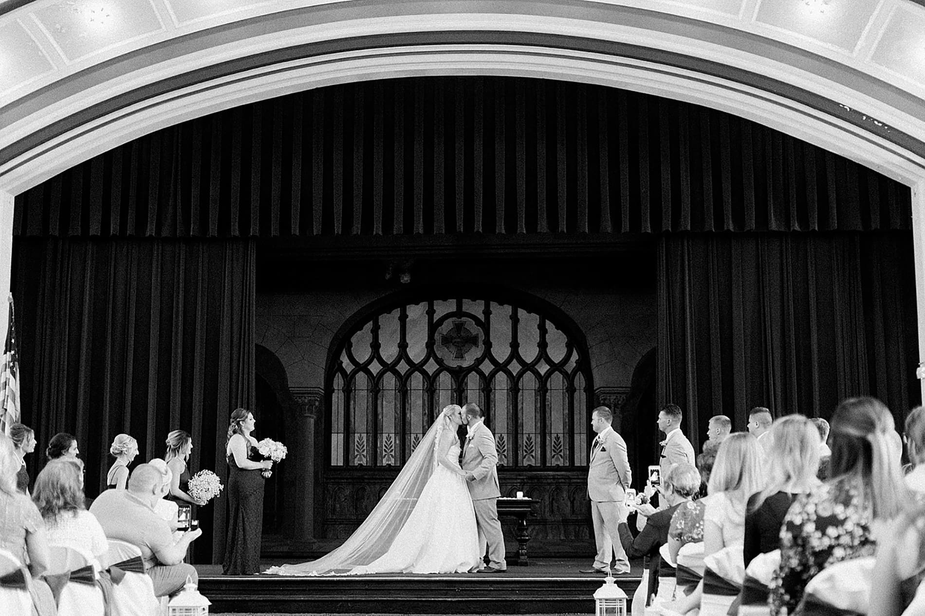 Arielle Peters Photography | Bride and groom kissing at the alter on wedding day at the Freemasons Hall in Fort Wayne, Indiana.