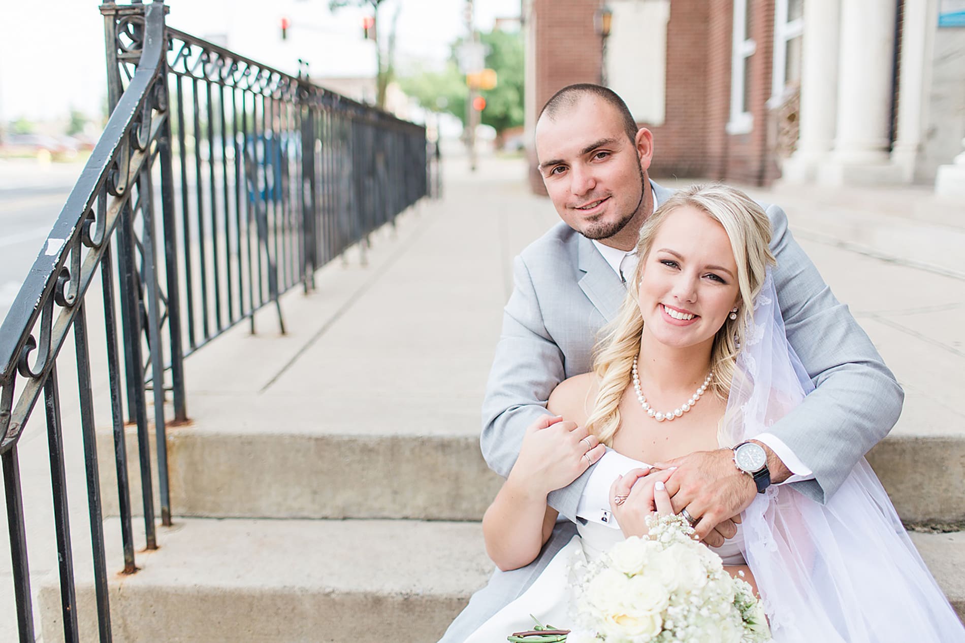 Arielle Peters Photography | Bride and groom sitting on church steps on wedding day at the Freemasons Hall in Fort Wayne, Indiana.