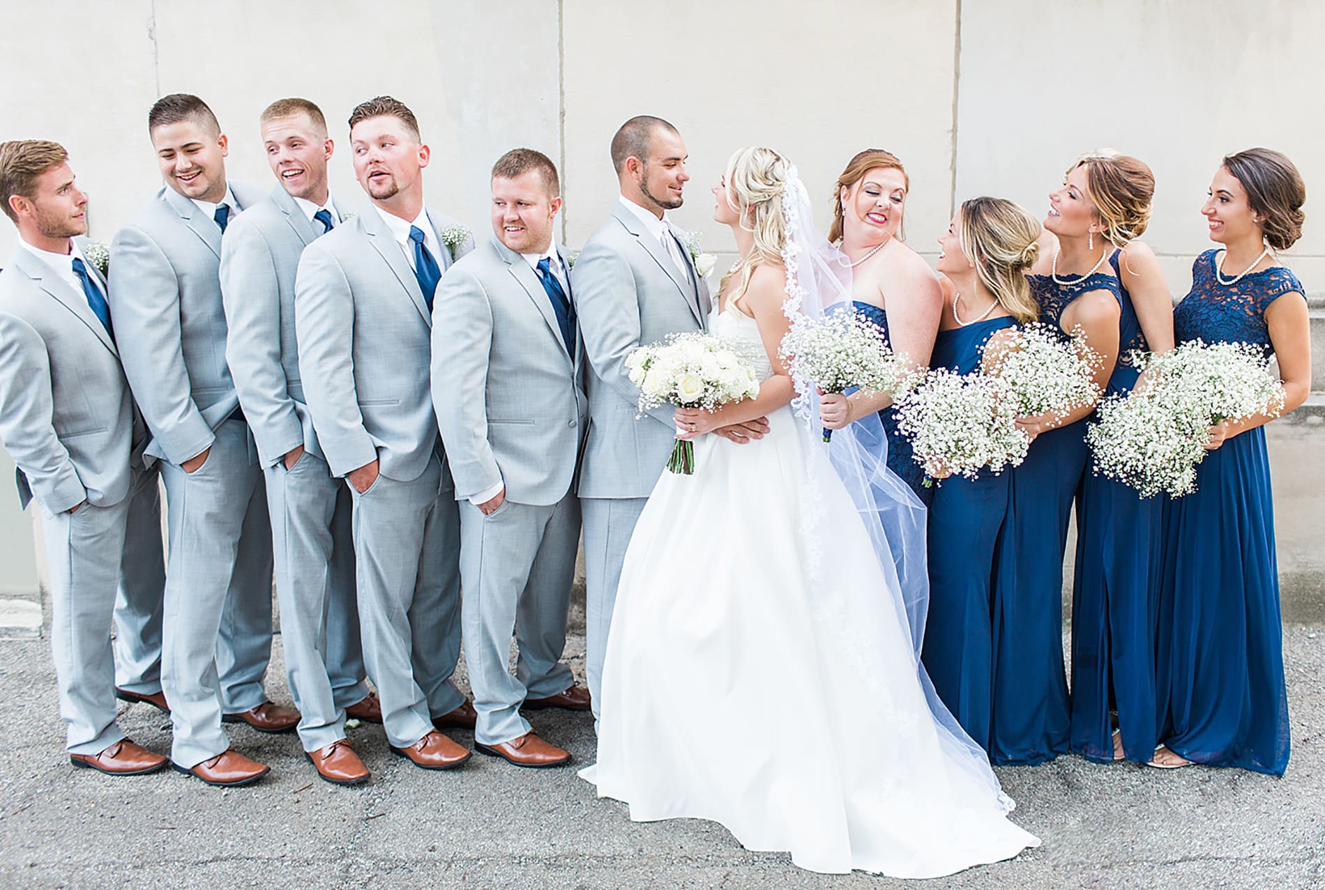 Arielle Peters Photography | Wedding party standing next to limestone building on wedding day at the Freemasons Hall in Fort Wayne, Indiana.