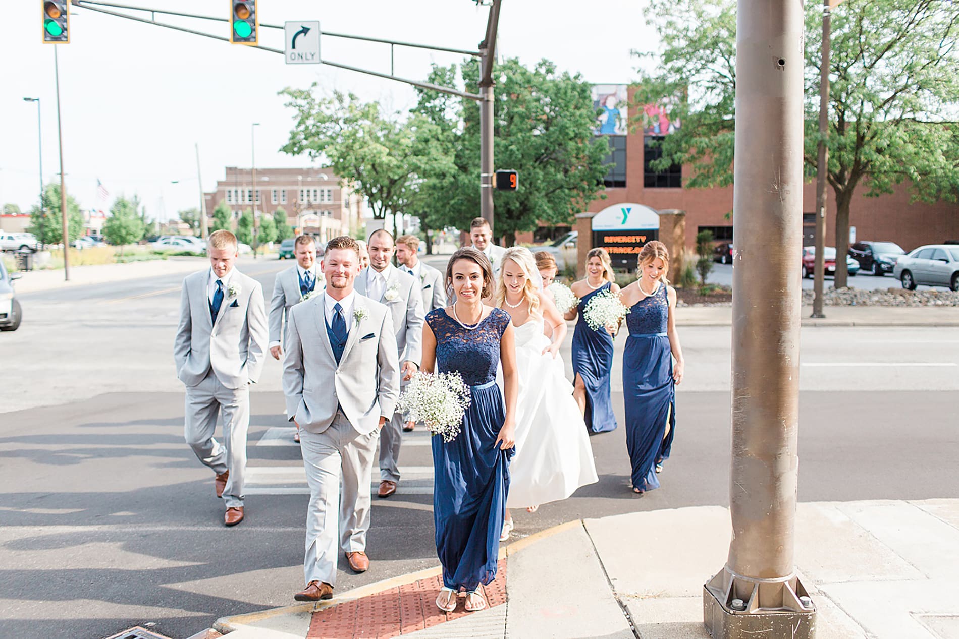 Arielle Peters Photography | Wedding party walking on city streets on wedding day at the Freemasons Hall in Fort Wayne, Indiana.