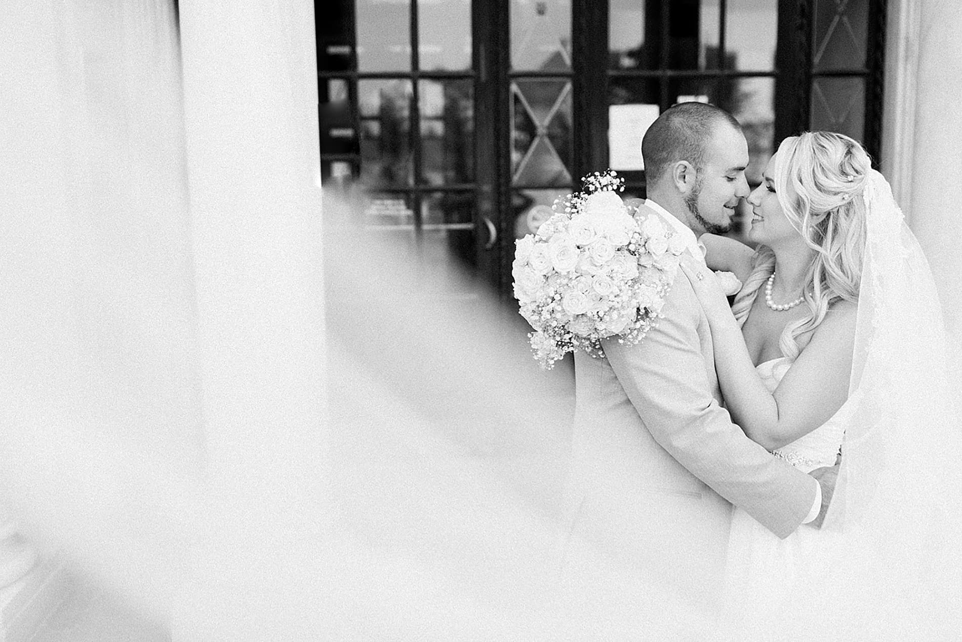 Arielle Peters Photography | Bride and groom almost kissing under veil on wedding day at the Freemasons Hall in Fort Wayne, Indiana.