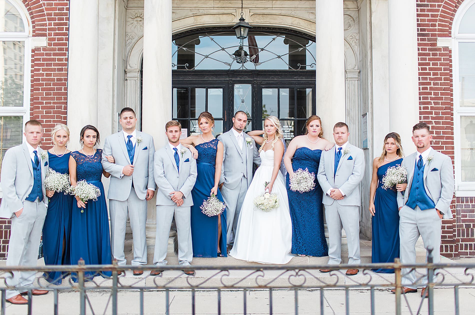 Arielle Peters Photography | Wedding party standing next to brick building on wedding day at the Freemasons Hall in Fort Wayne, Indiana.