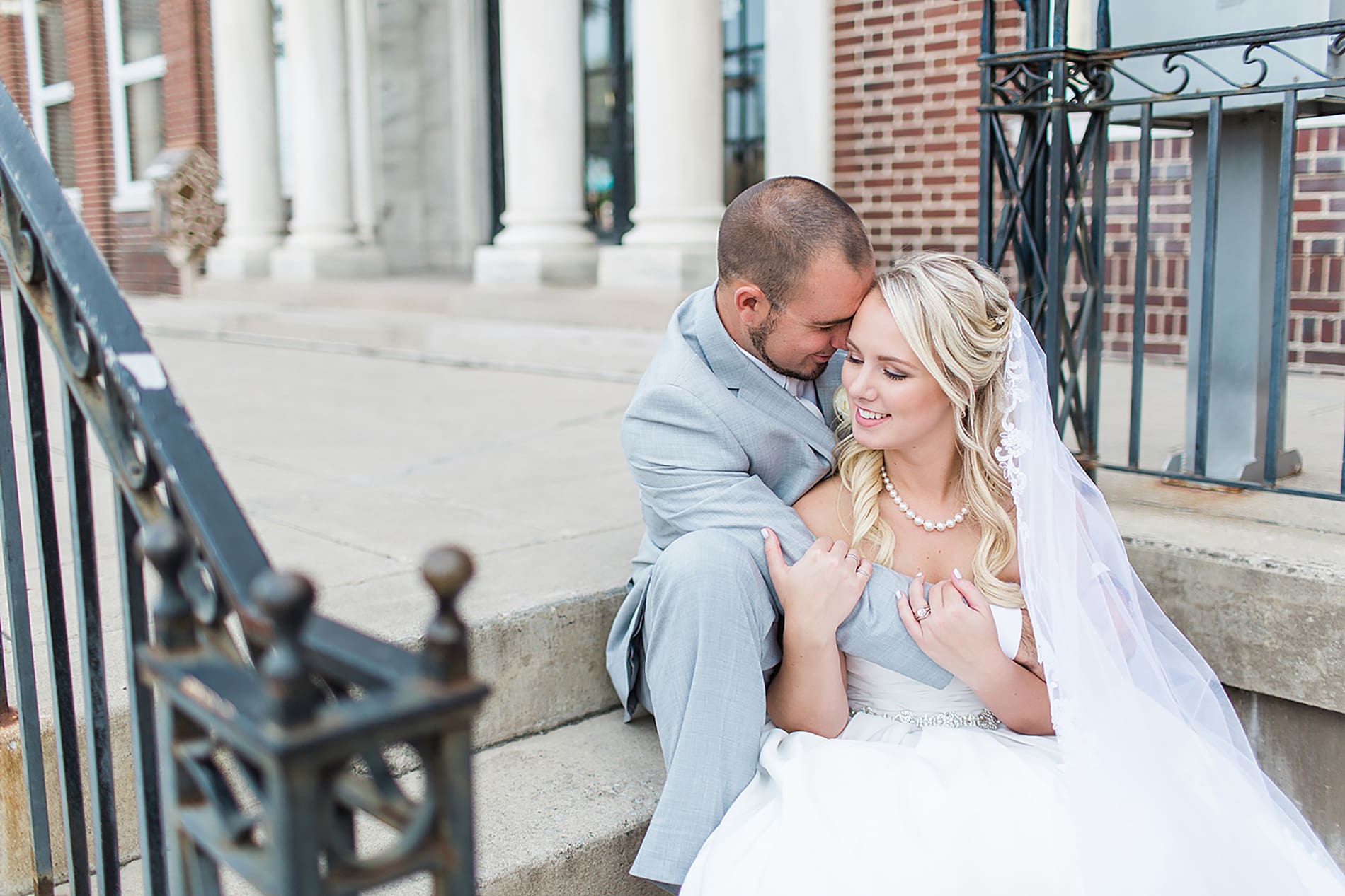 Arielle Peters Photography | Bride and groom sitting on church steps on wedding day at the Freemasons Hall in Fort Wayne, Indiana.