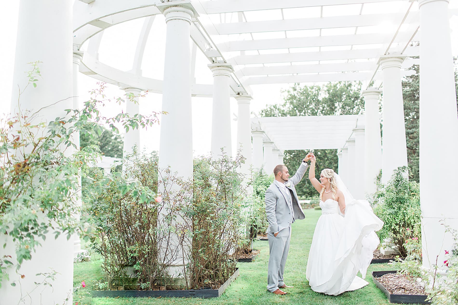 Arielle Peters Photography | Bride and groom slow dancing in overgrown rose garden on wedding day at the Freemasons Hall in Fort Wayne, Indiana.