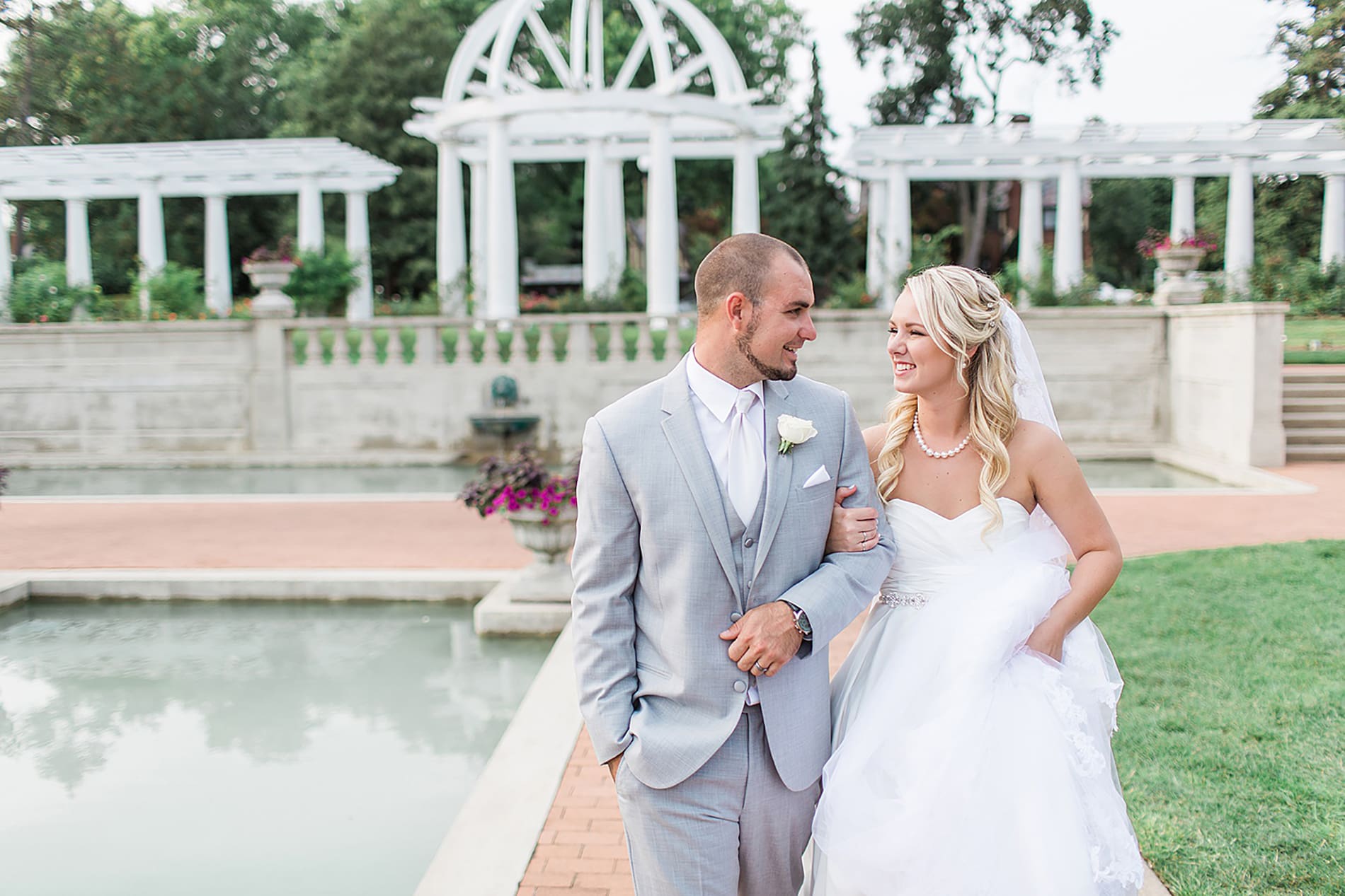 Arielle Peters Photography | Bride and groom walking in rose garden on wedding day at the Freemasons Hall in Fort Wayne, Indiana.