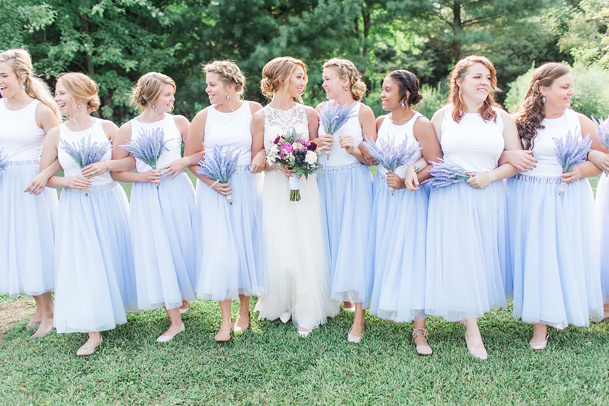 Arielle Peters Photography | Bride and bridesmaids next to large trees on wedding day at Willowfield Lavender Farm in Mooresville, Indiana. 
