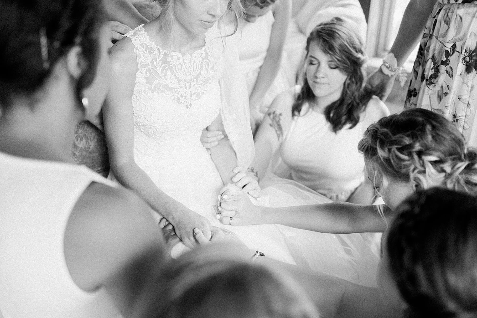 Arielle Peters Photography | Bride and bridesmaids praying together on wedding day at Willowfield Lavender Farm in Mooresville, Indiana. 