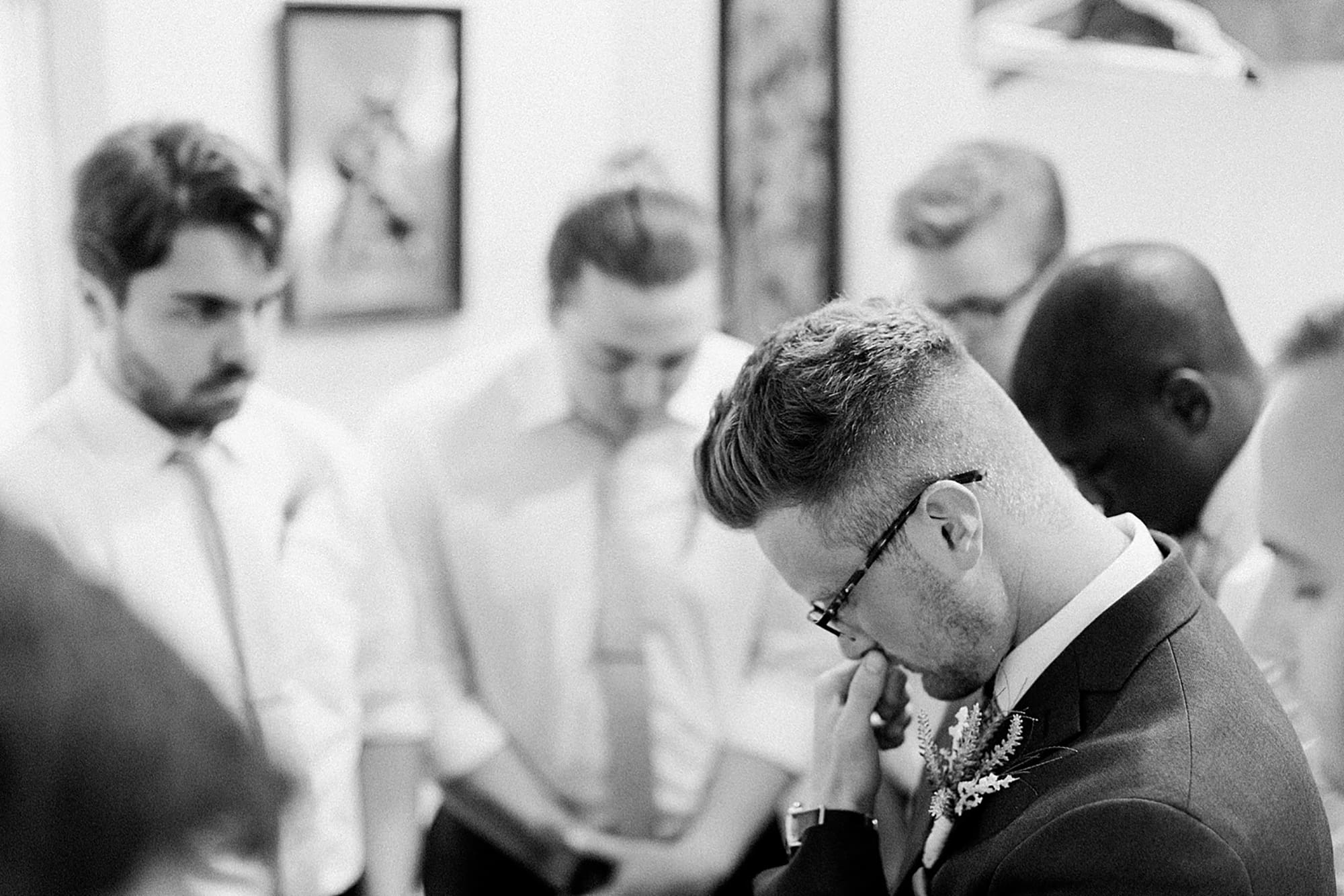 Arielle Peters Photography | Groom and groomsmen praying together on wedding day at Willowfield Lavender Farm in Mooresville, Indiana. 