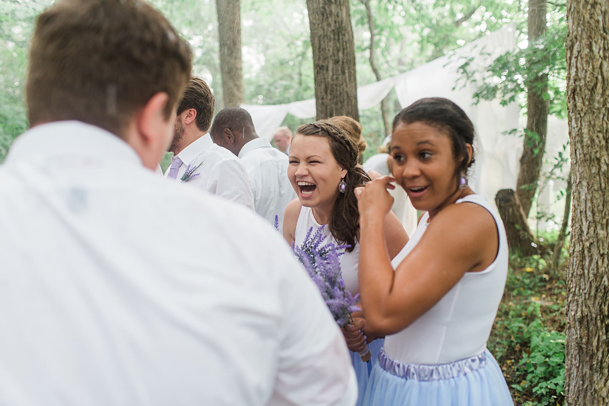 Arielle Peters Photography | Bridesmaids laughing in the rain at an outdoor wedding at Willowfield Lavender Farm in Mooresville, Indiana. 
