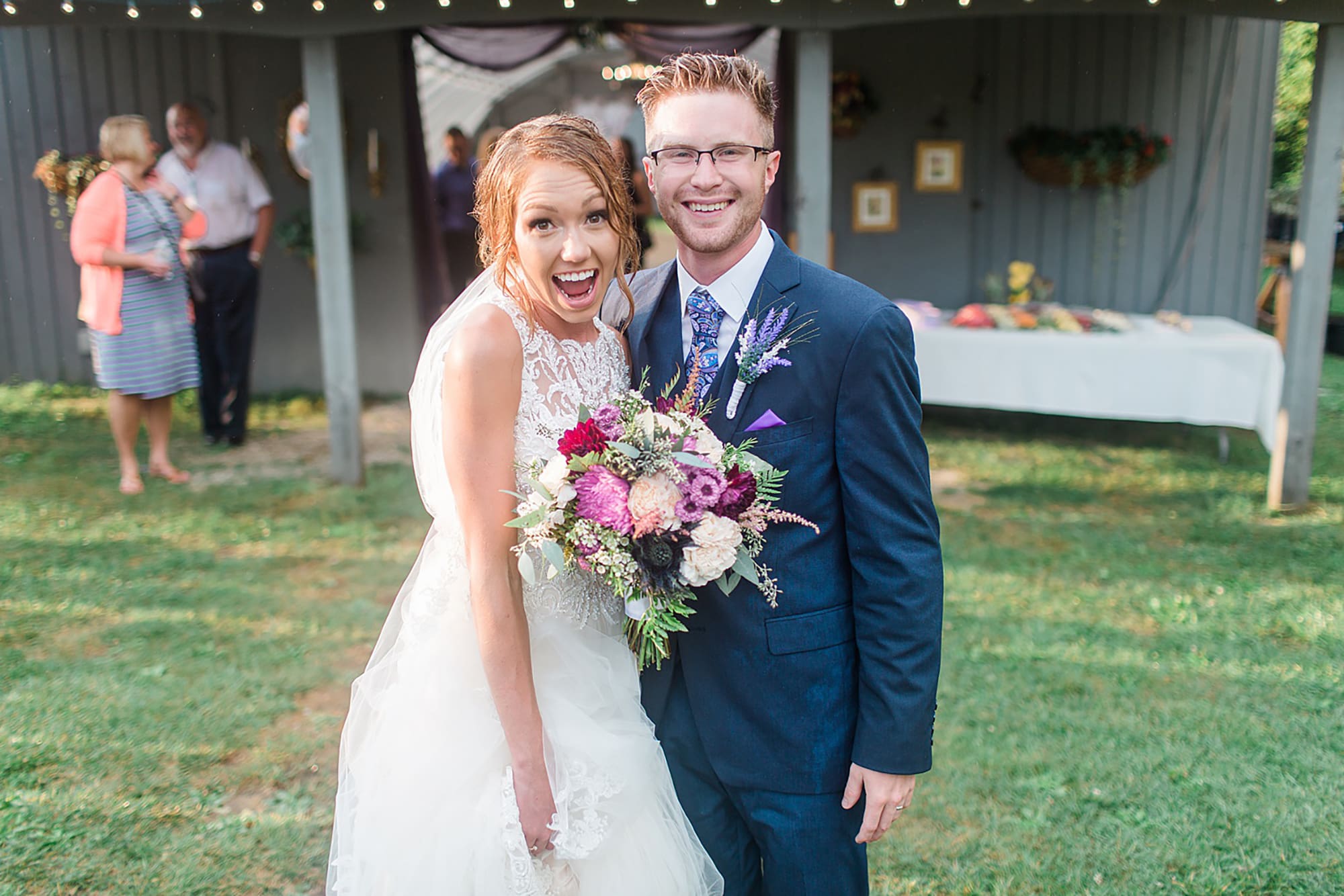 Arielle Peters Photography | Bride and groom laughing in the rain at an outdoor wedding at Willowfield Lavender Farm in Mooresville, Indiana. 