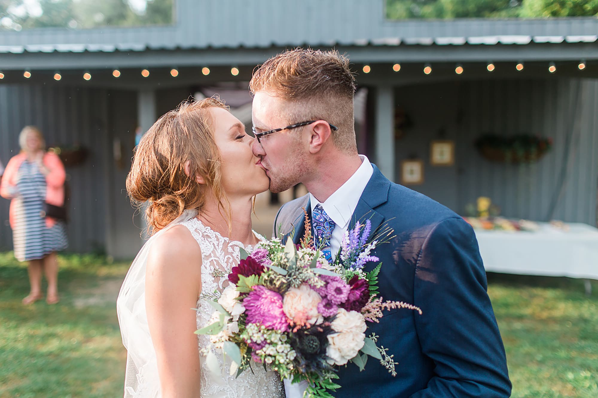 Arielle Peters Photography | Bride and groom kissing in the rain at an outdoor wedding at Willowfield Lavender Farm in Mooresville, Indiana. 