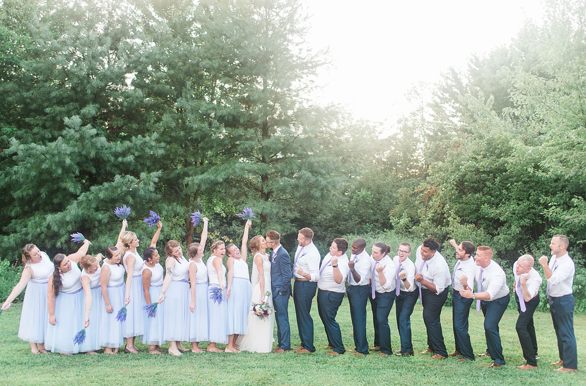 Arielle Peters Photography | Wedding party cheering next to large trees at outdoor wedding at Willowfield Lavender Farm in Mooresville, Indiana. 