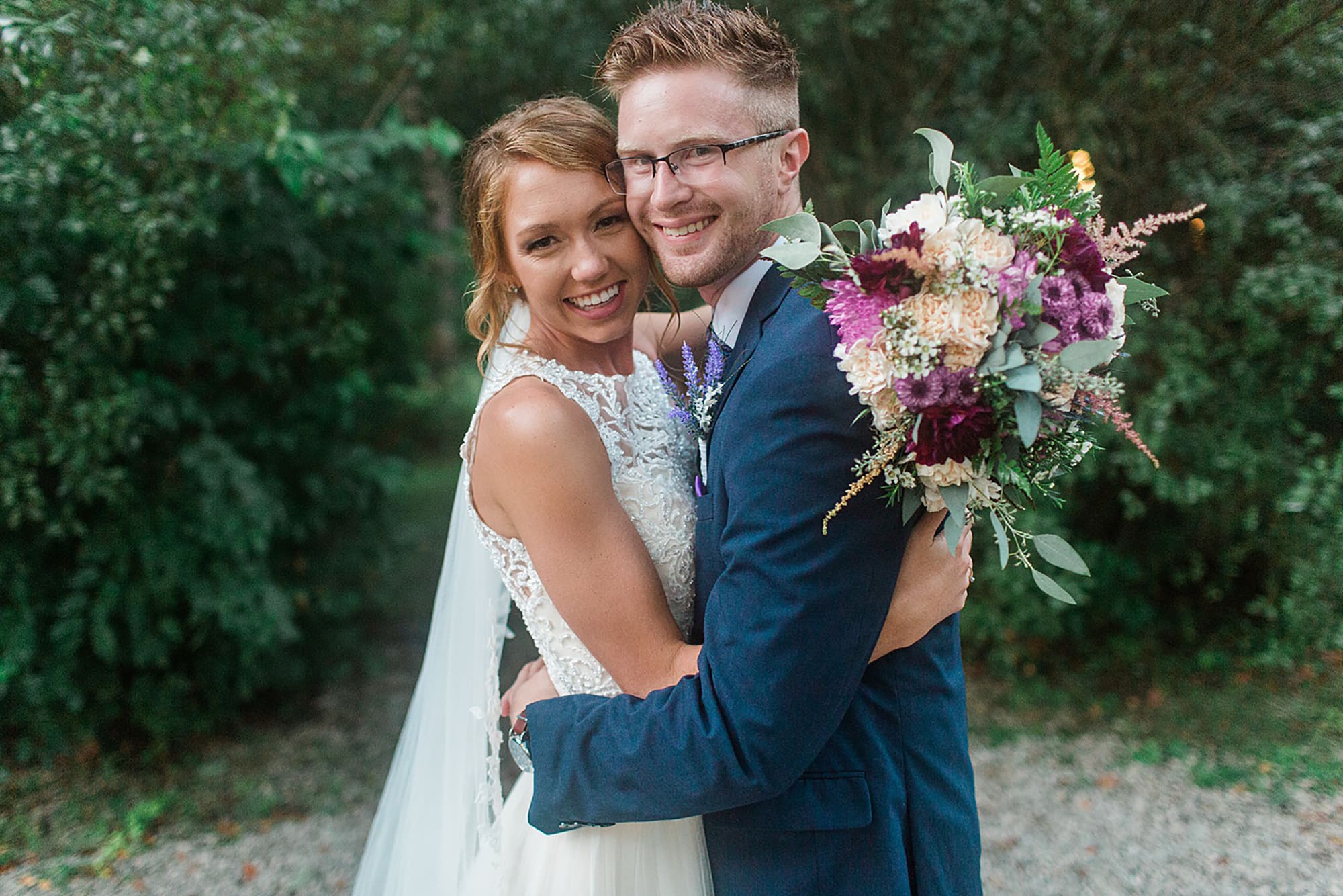 Arielle Peters Photography | Bride and groom hugging under tunnel of trees at outdoor wedding at Willowfield Lavender Farm in Mooresville, Indiana. 