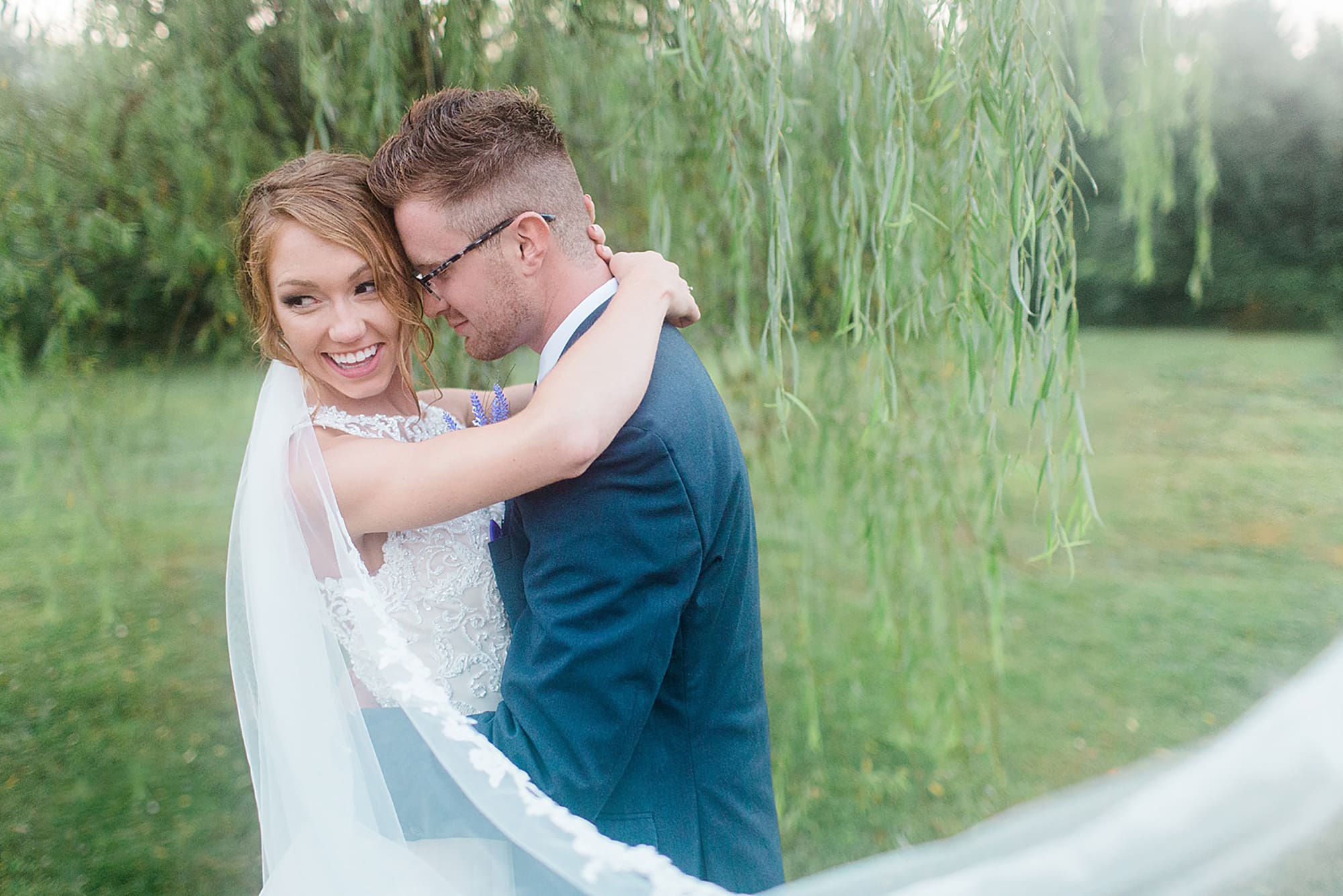 Arielle Peters Photography | Bride and groom hugging under willow tree at outdoor wedding at Willowfield Lavender Farm in Mooresville, Indiana. 
