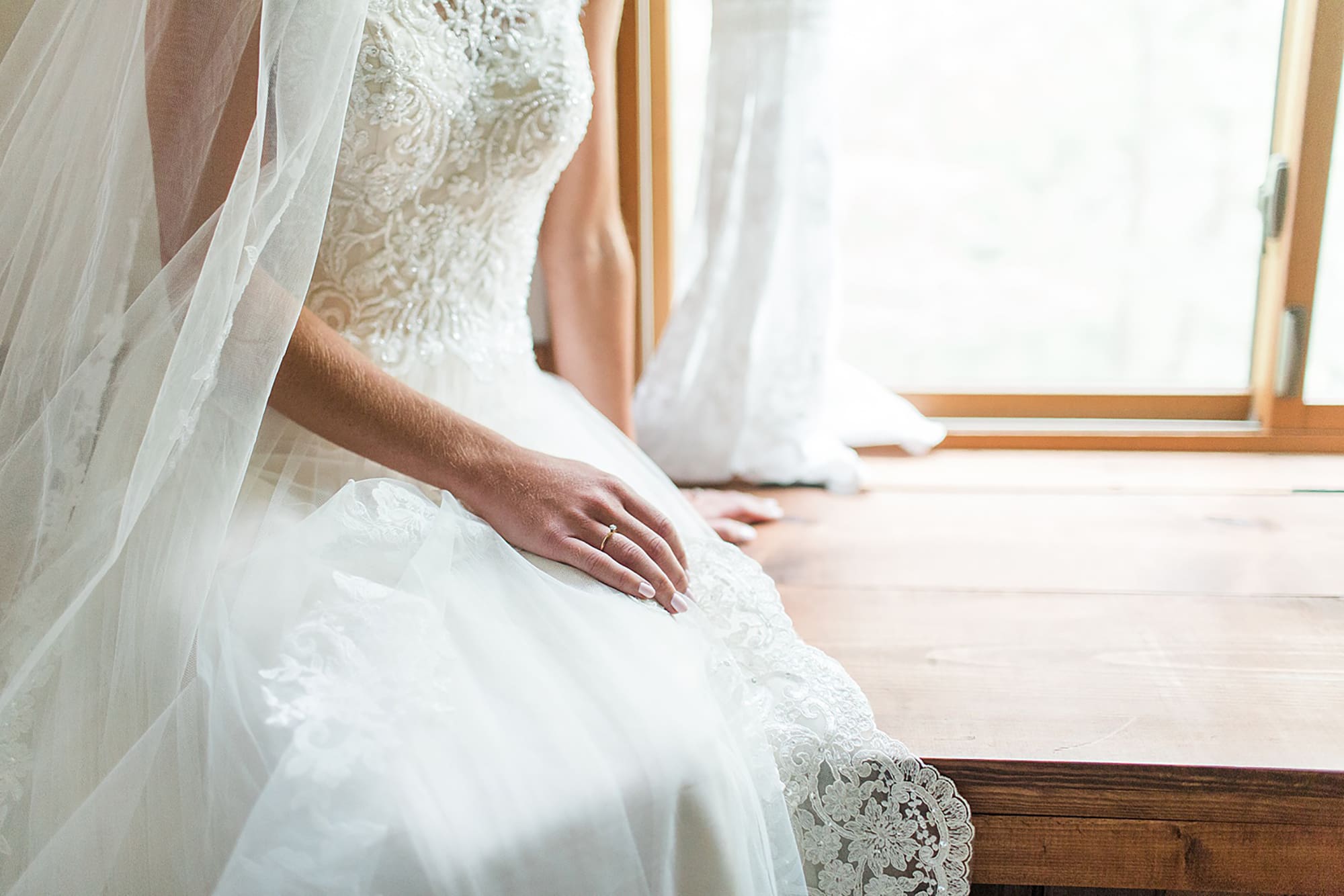 Arielle Peters Photography | Bride sitting on wooden window sill on wedding day at Willowfield Lavender Farm in Mooresville, Indiana. 