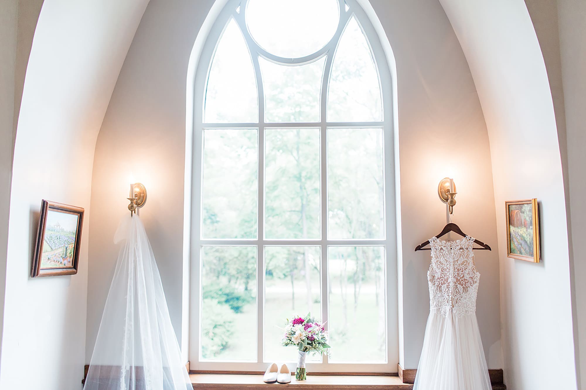 Arielle Peters Photography | Wedding gown hanging in large window on wedding day at Willowfield Lavender Farm in Mooresville, Indiana. 