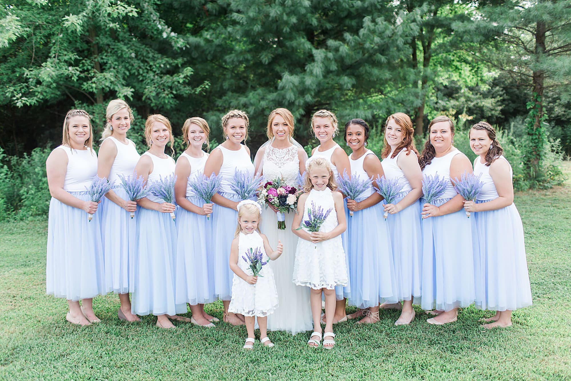 Arielle Peters Photography | Bride and bridesmaids standing next to large trees on wedding day at Willowfield Lavender Farm in Mooresville, Indiana. 