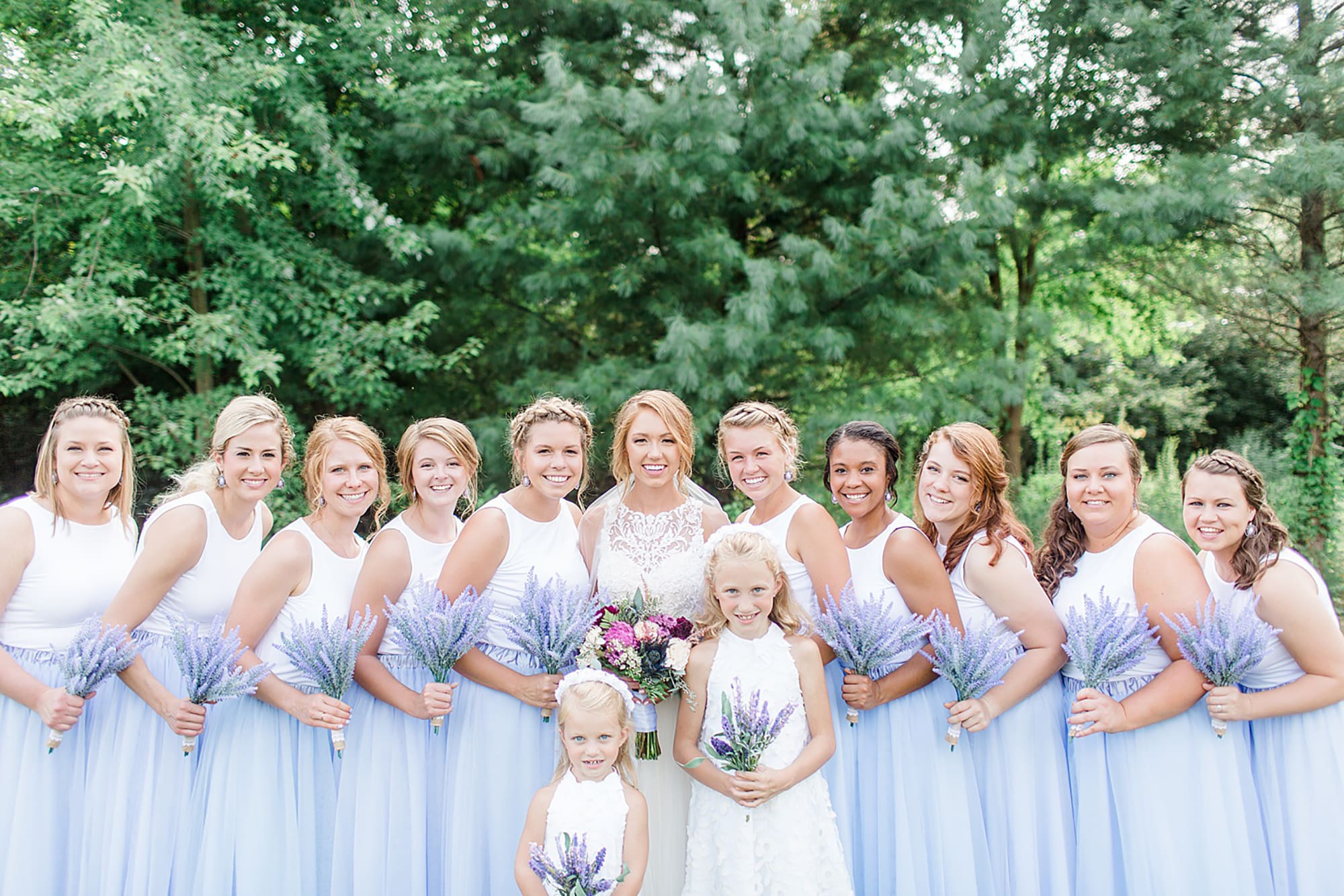 Arielle Peters Photography | Bride and bridesmaids standing next to large trees on wedding day at Willowfield Lavender Farm in Mooresville, Indiana. 