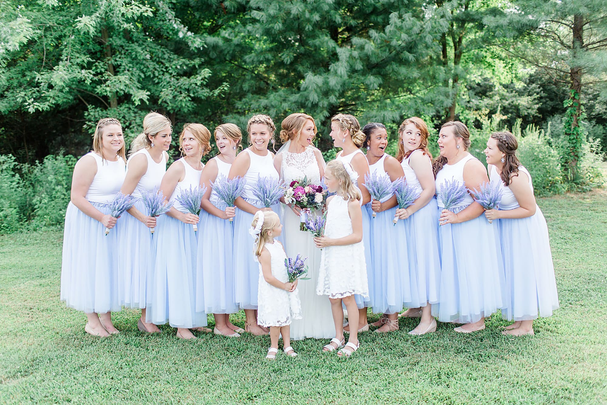 Arielle Peters Photography | Bride and bridesmaids next to large trees on wedding day at Willowfield Lavender Farm in Mooresville, Indiana. 