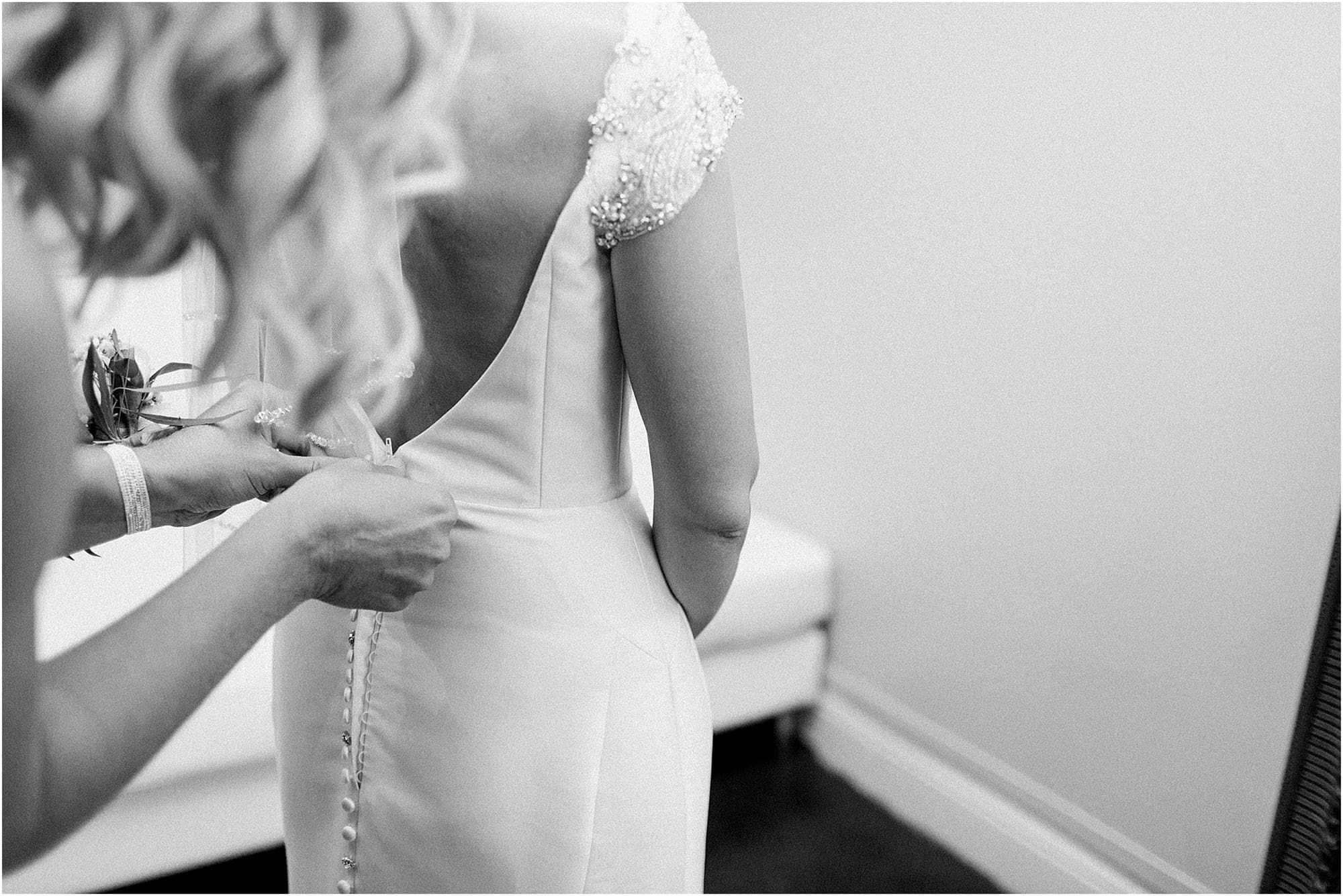 Arielle Peters Photography | Mother of bride helping bride get ready on wedding day at the Uptown Center in Michigan City, Indiana.