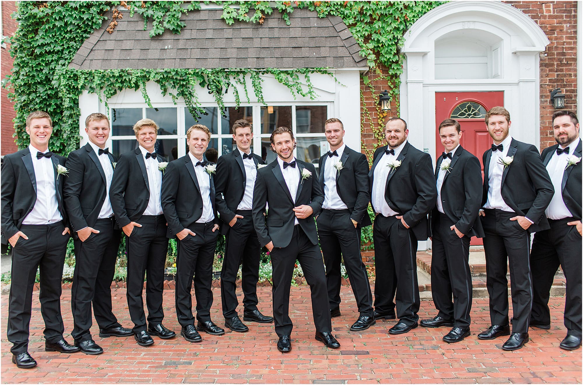 Arielle Peters Photography | Groom and groomsmen next to ivy-covered building on wedding day at the Uptown Center in Michigan City, Indiana.
