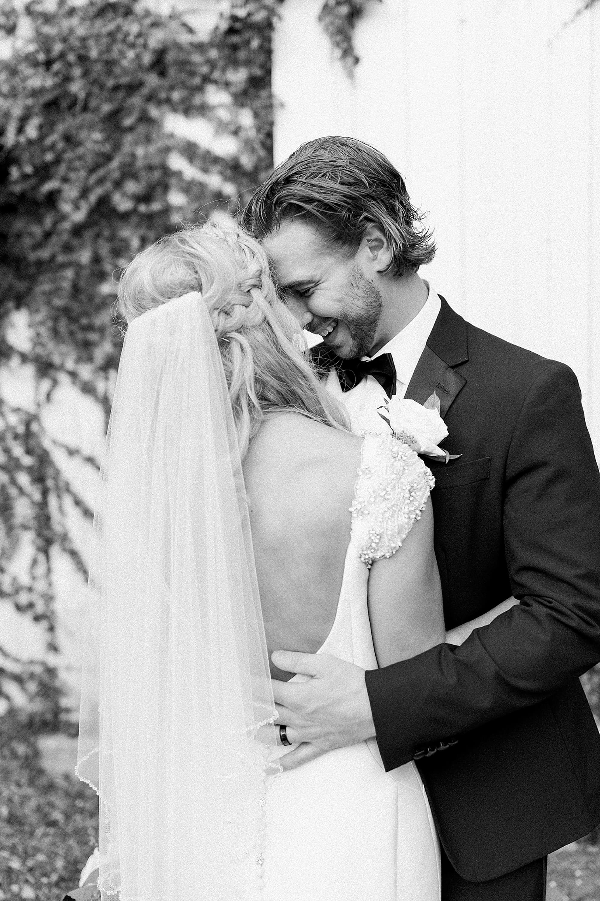Arielle Peters Photography | Bride and groom next to ivy-covered walls on wedding day at the Uptown Center in Michigan City, Indiana.