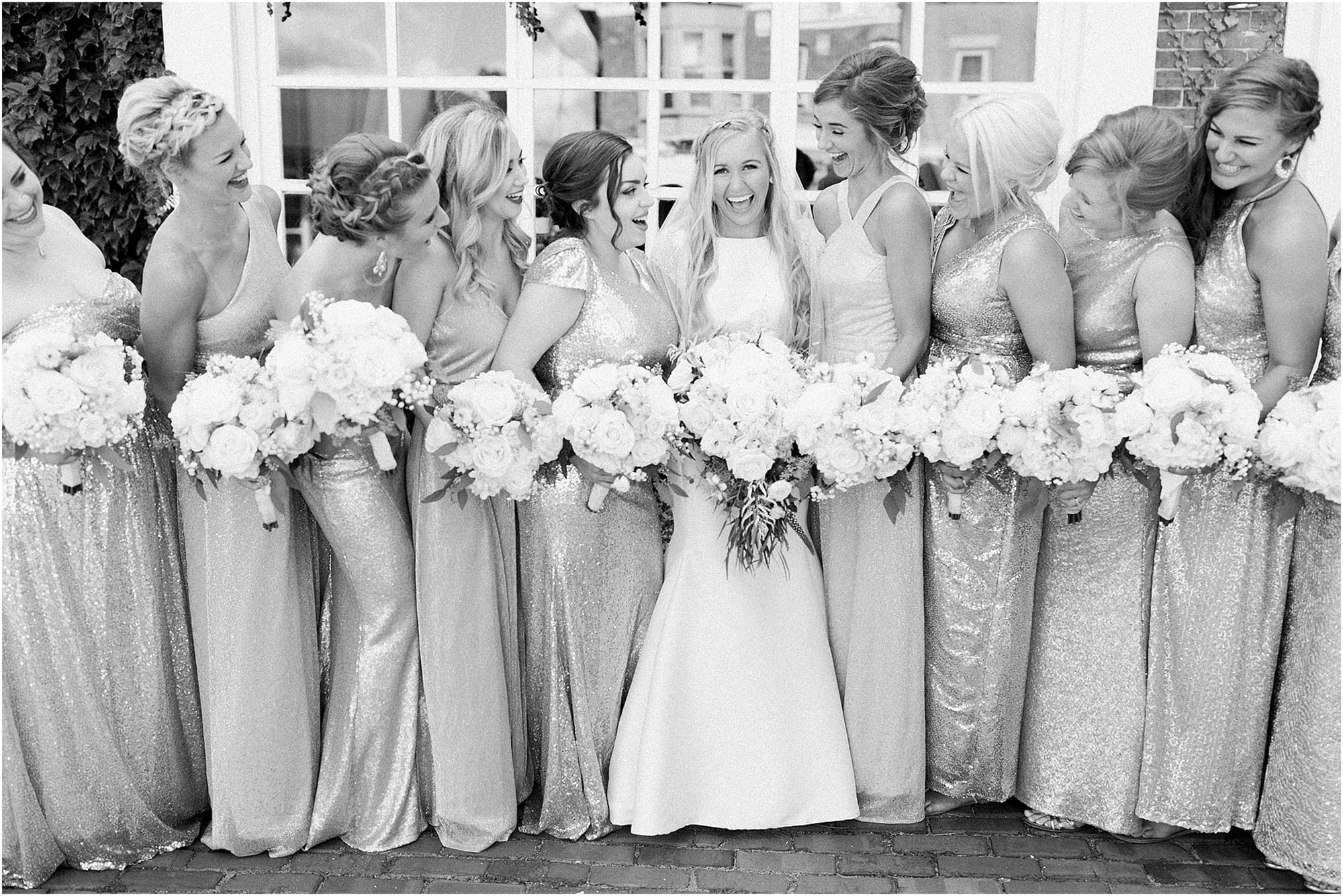 Arielle Peters Photography | Bride and bridesmaids next to ivy-covered building on wedding day at the Uptown Center in Michigan City, Indiana.