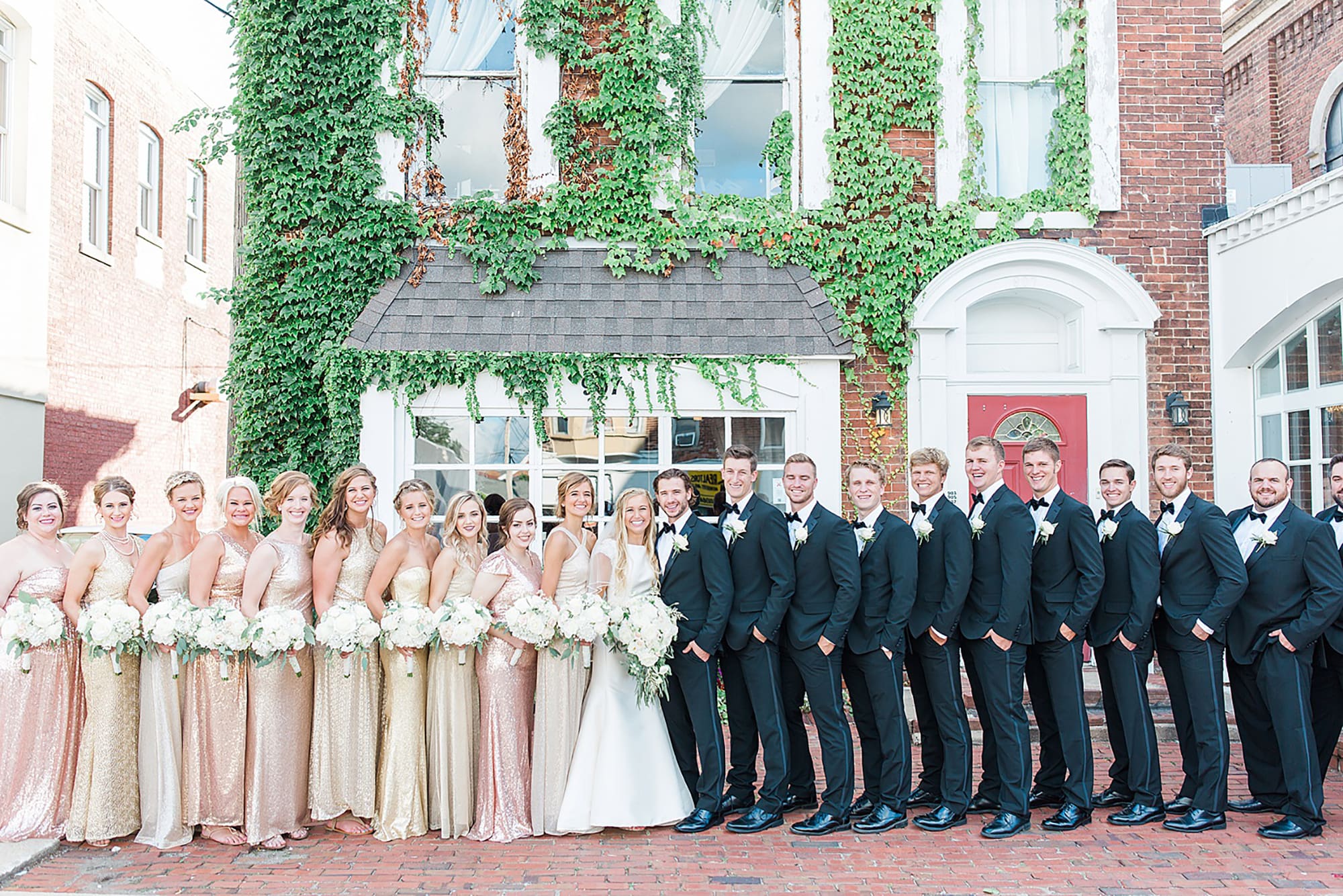 Arielle Peters Photography | Wedding party next to ivy-covered building on wedding day at the Uptown Center in Michigan City, Indiana.