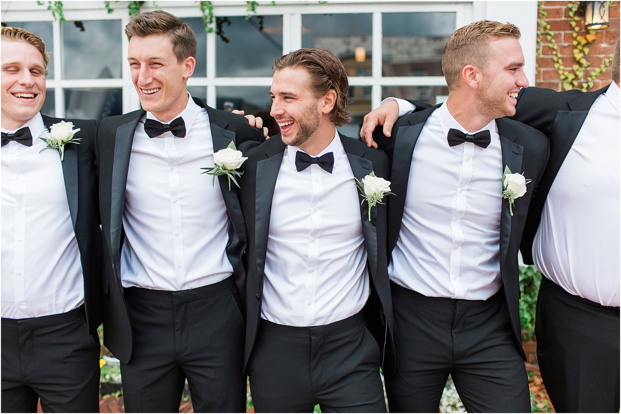Arielle Peters Photography | Groom and groomsmen next to ivy-covered windows on wedding day at the Uptown Center in Michigan City, Indiana.