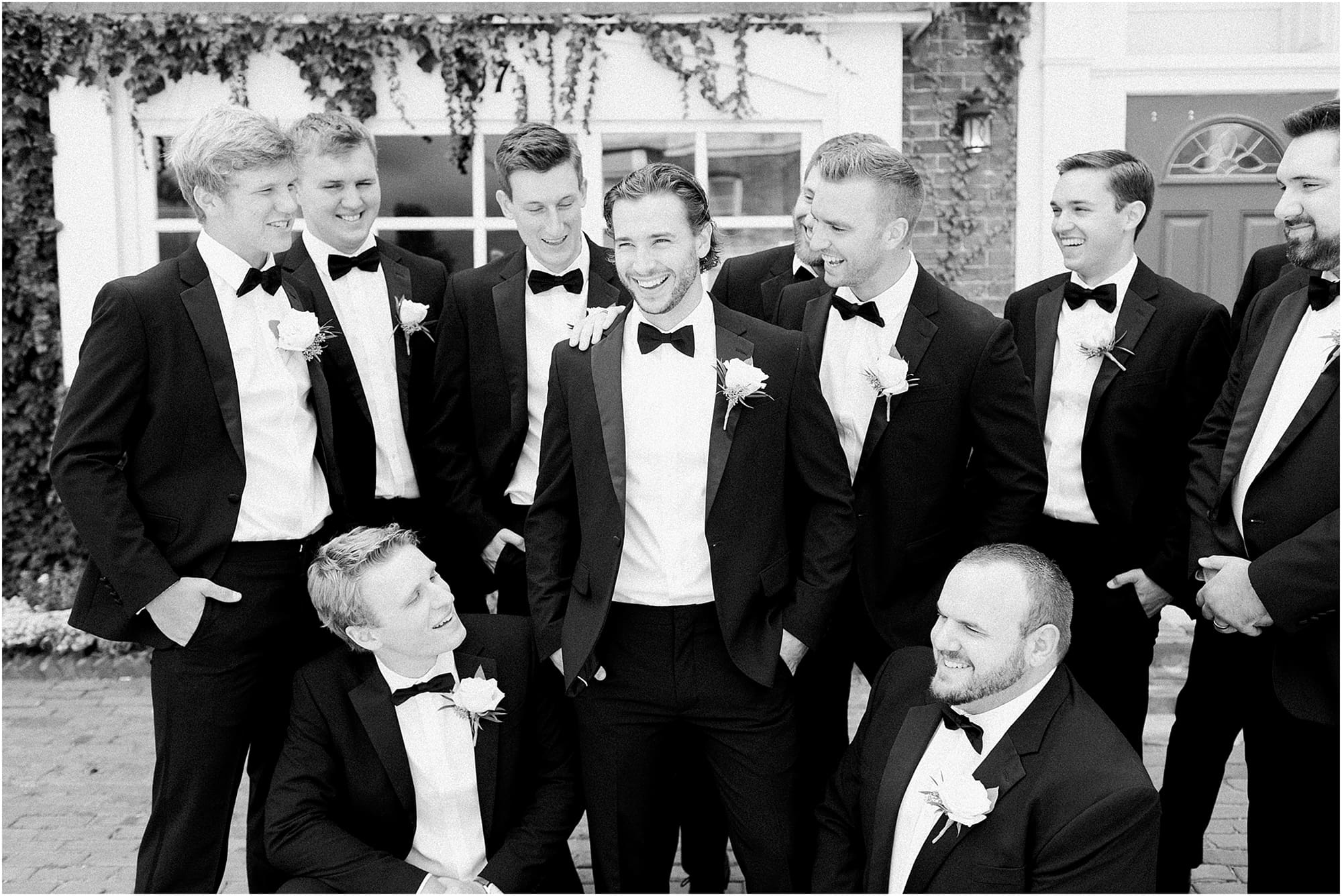 Arielle Peters Photography | Groom and groomsmen next to ivy-covered walls on wedding day at the Uptown Center in Michigan City, Indiana.