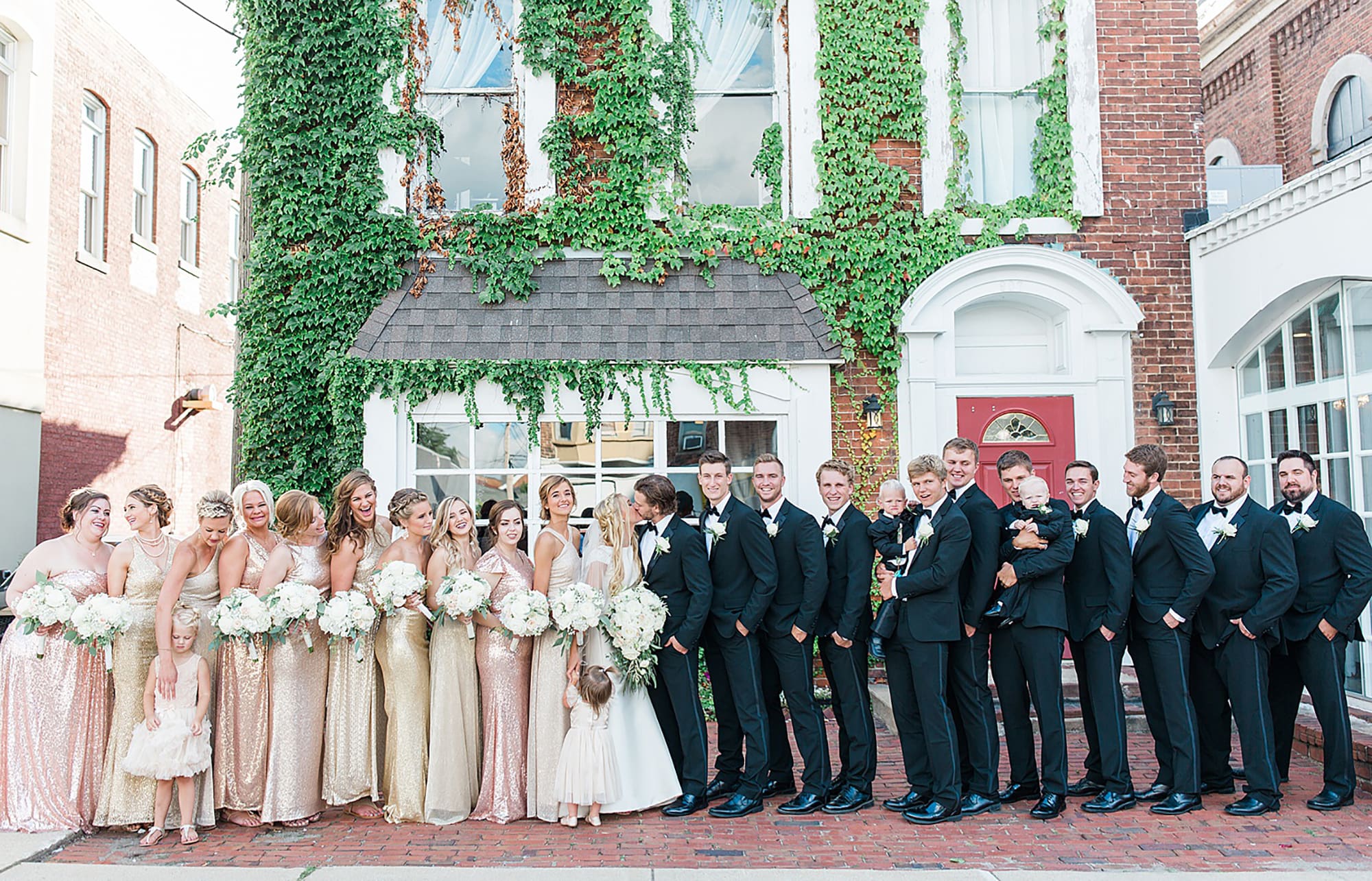 Arielle Peters Photography | Wedding party next to ivy-covered building on wedding day at the Uptown Center in Michigan City, Indiana.