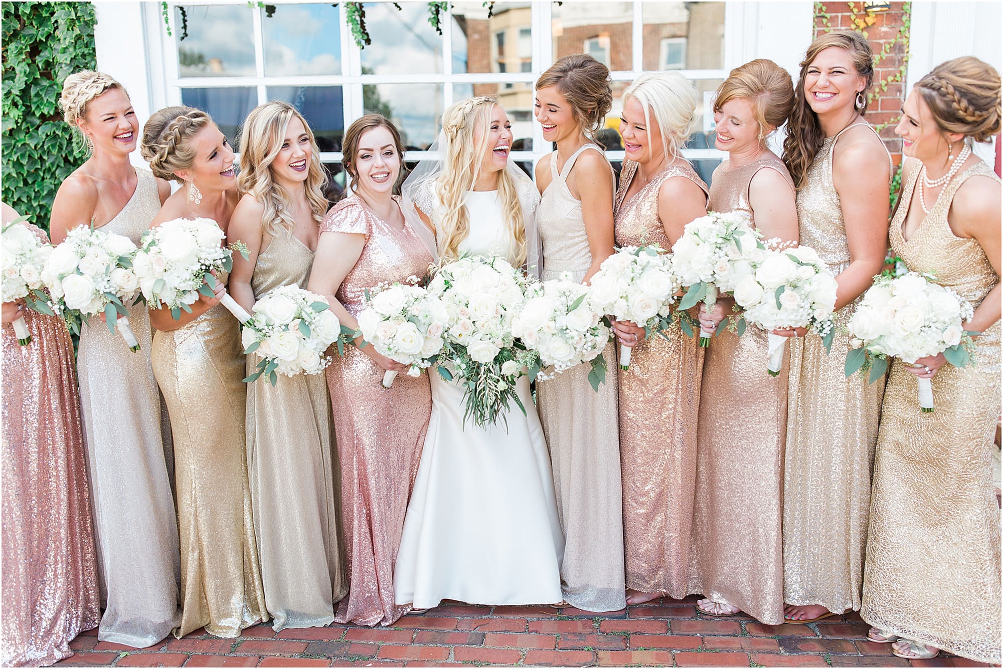 Arielle Peters Photography | Bride and bridesmaids next to ivy-covered windows on wedding day at the Uptown Center in Michigan City, Indiana.