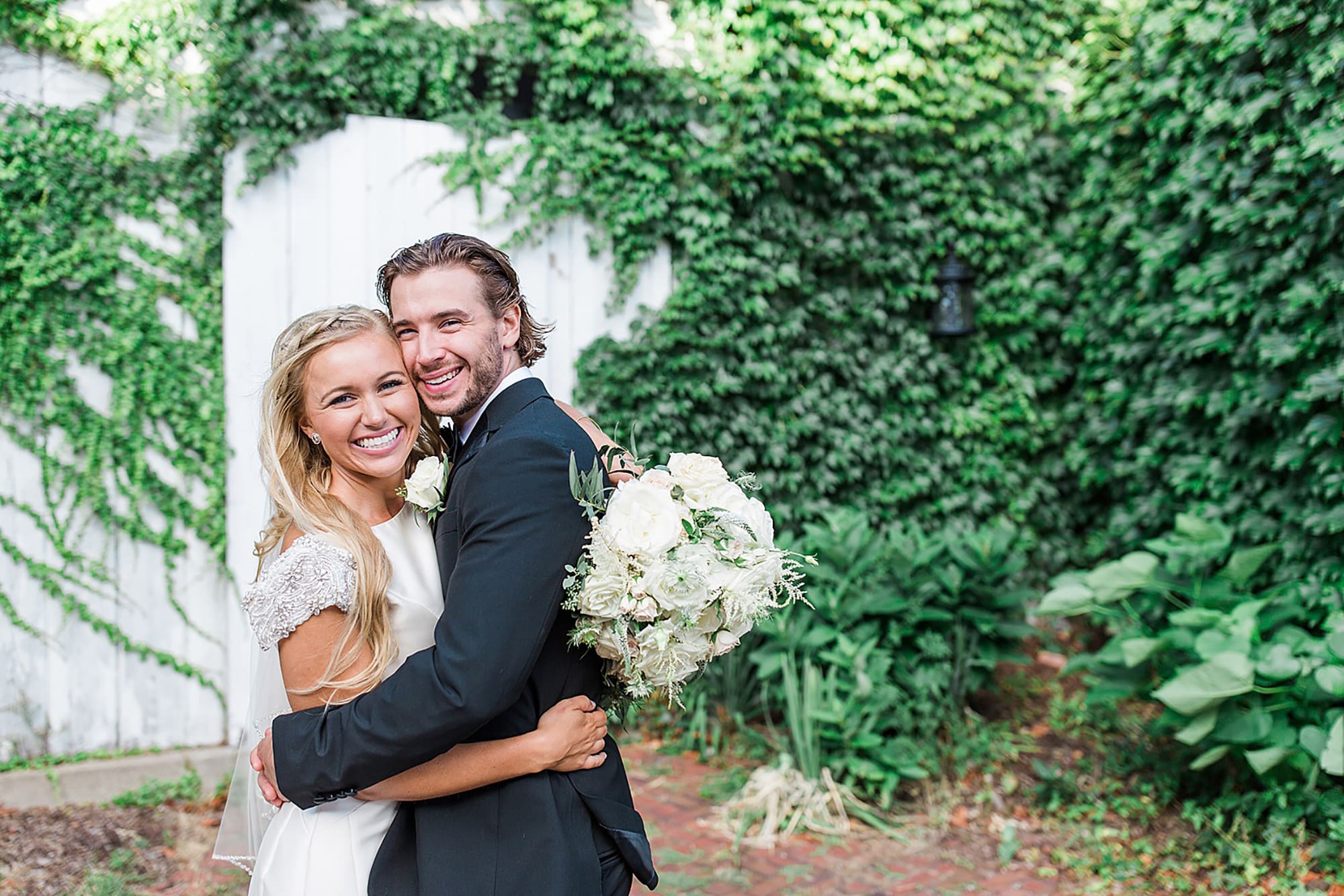 Arielle Peters Photography | Bride and groom next to ivy-covered walls on wedding day at the Uptown Center in Michigan City, Indiana.