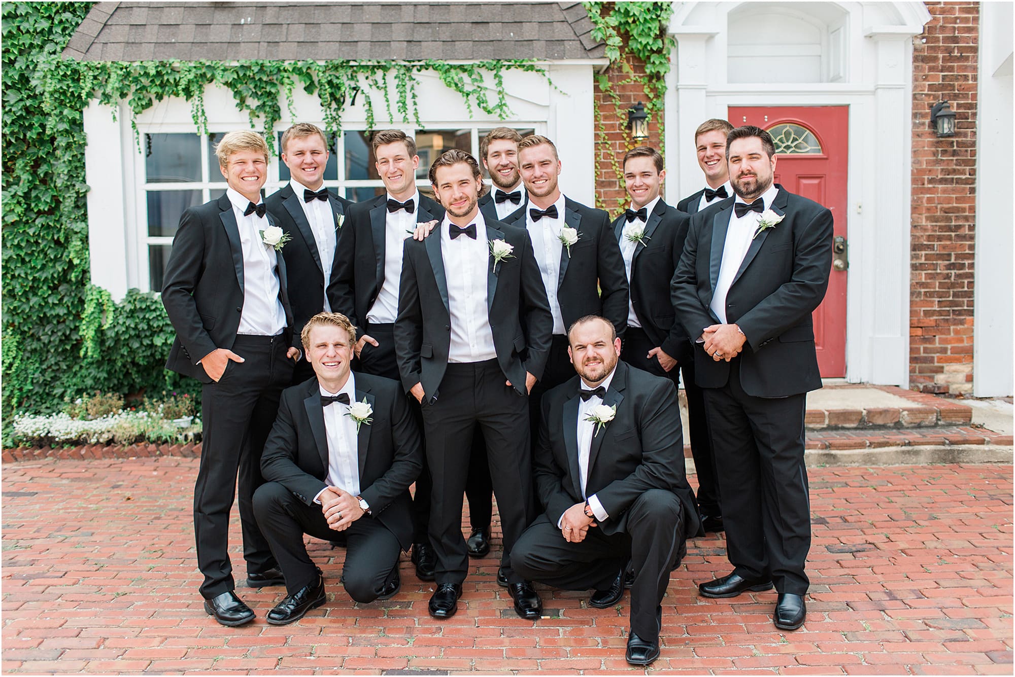 Arielle Peters Photography | Groom and groomsmen next to ivy-covered building on wedding day at the Uptown Center in Michigan City, Indiana.
