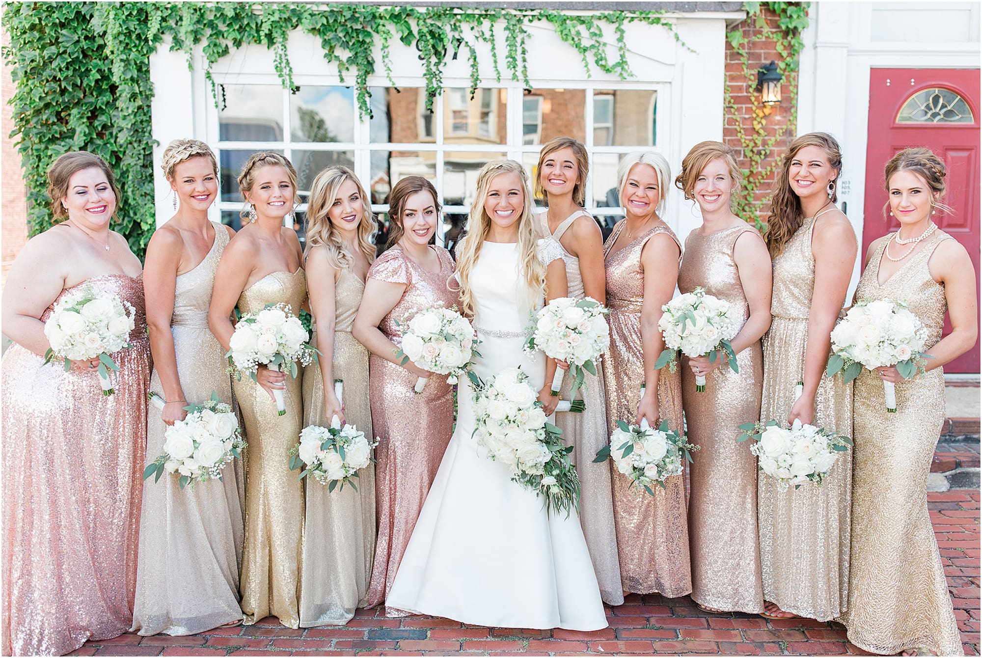 Arielle Peters Photography | Bride and bridesmaids next to ivy-covered building on wedding day at the Uptown Center in Michigan City, Indiana.
