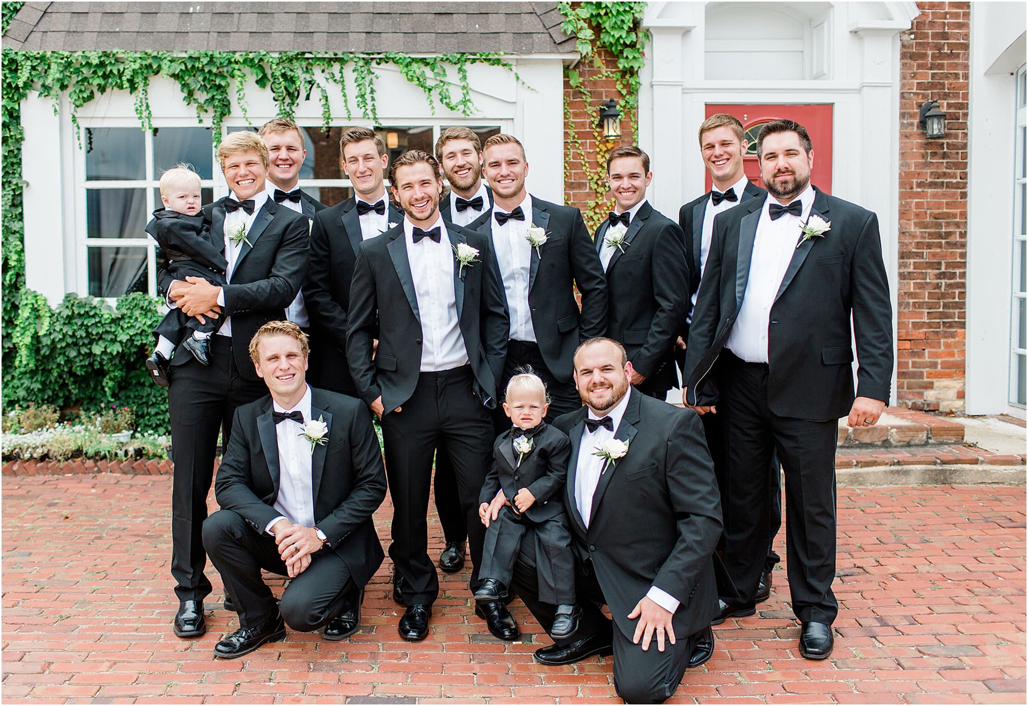 Arielle Peters Photography | Groom and groomsmen next to ivy-covered building on wedding day at the Uptown Center in Michigan City, Indiana.