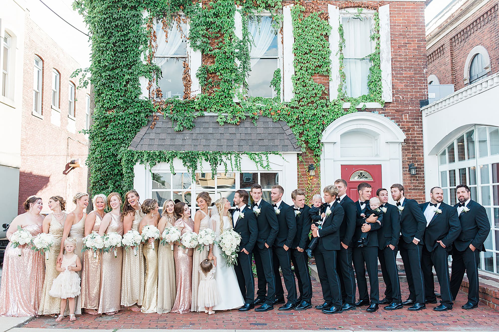 Arielle Peters Photography | Wedding party next to ivy-covered building on wedding day at the Uptown Center in Michigan City, Indiana.