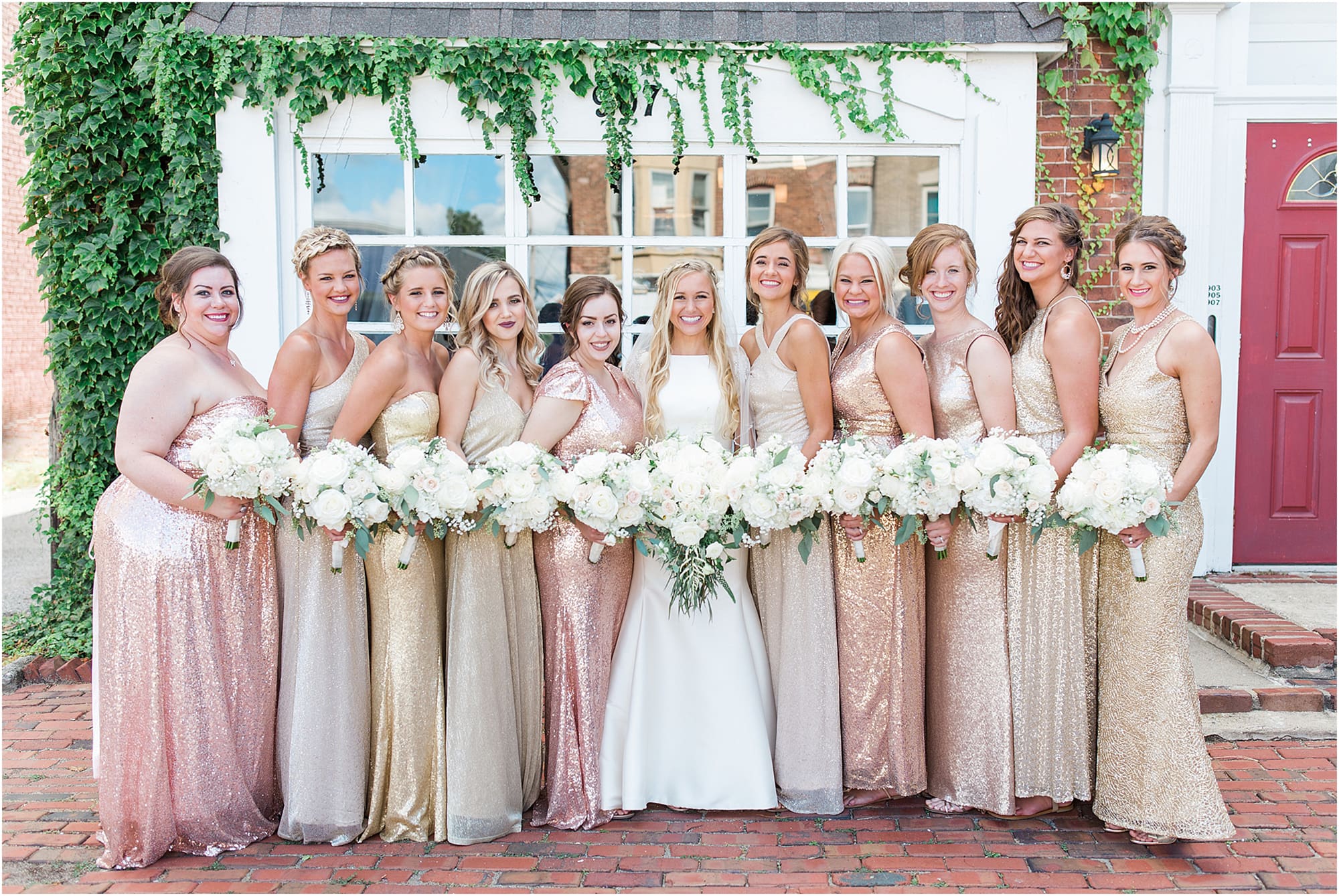 Arielle Peters Photography | Bride and bridesmaids next to ivy-covered building on wedding day at the Uptown Center in Michigan City, Indiana.