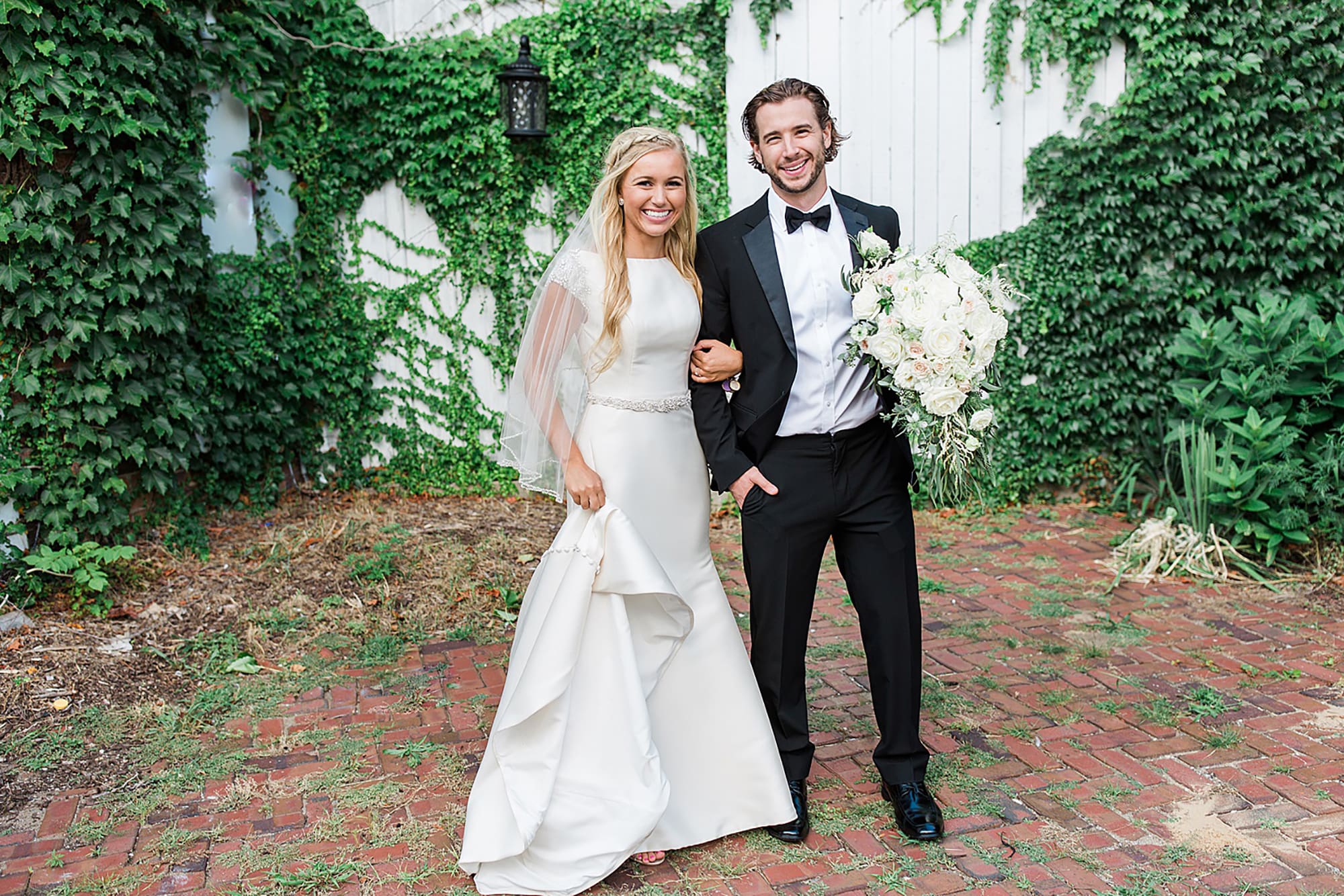 Arielle Peters Photography | Bride and groom next to ivy-covered walls on wedding day at the Uptown Center in Michigan City, Indiana.